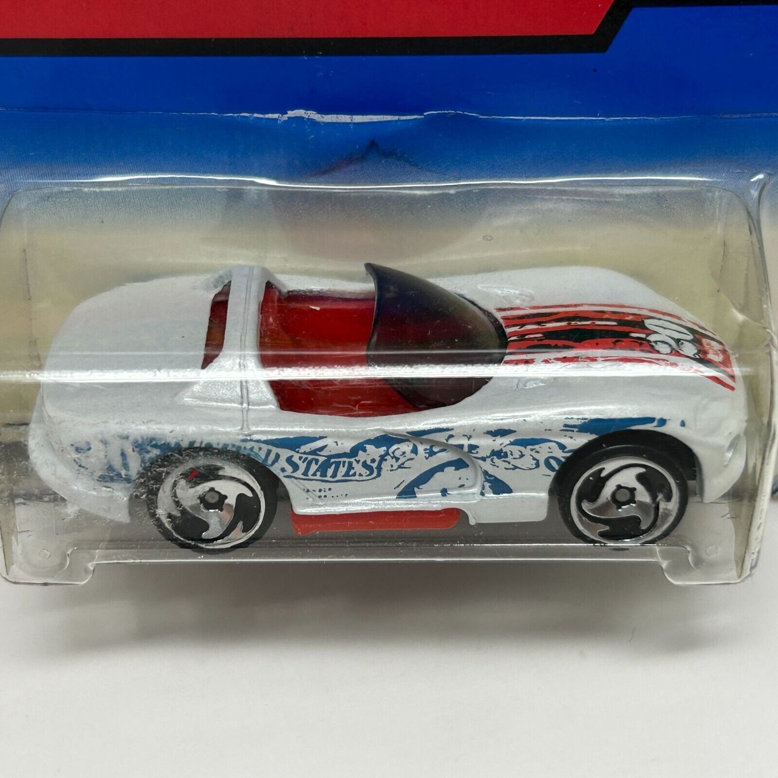 White Hot Wheels Dodge Viper with red accents and unique graphics, viewed from the front in packaging