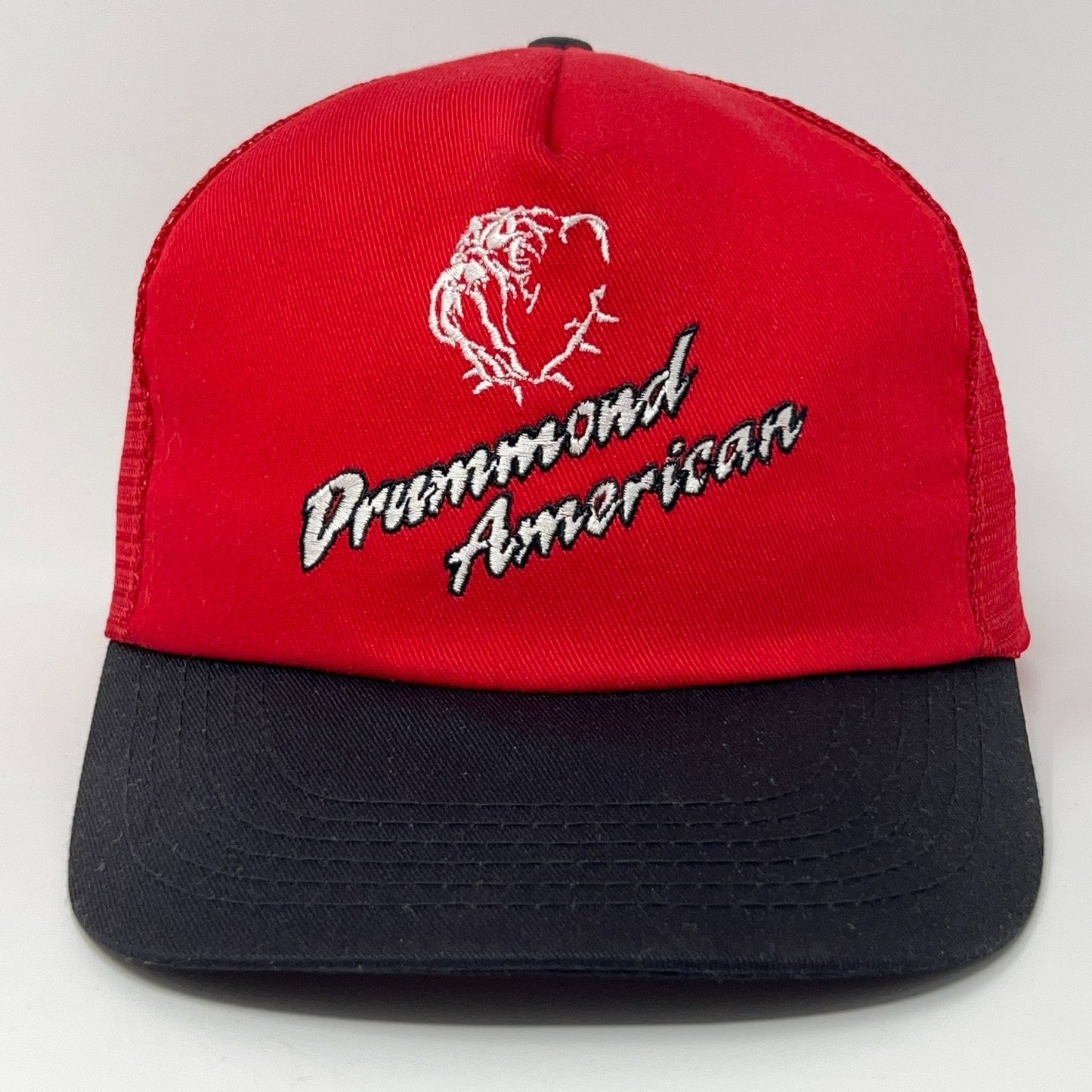 Red and black trucker cap hat featuring Drummond American logo on front for a vintage style