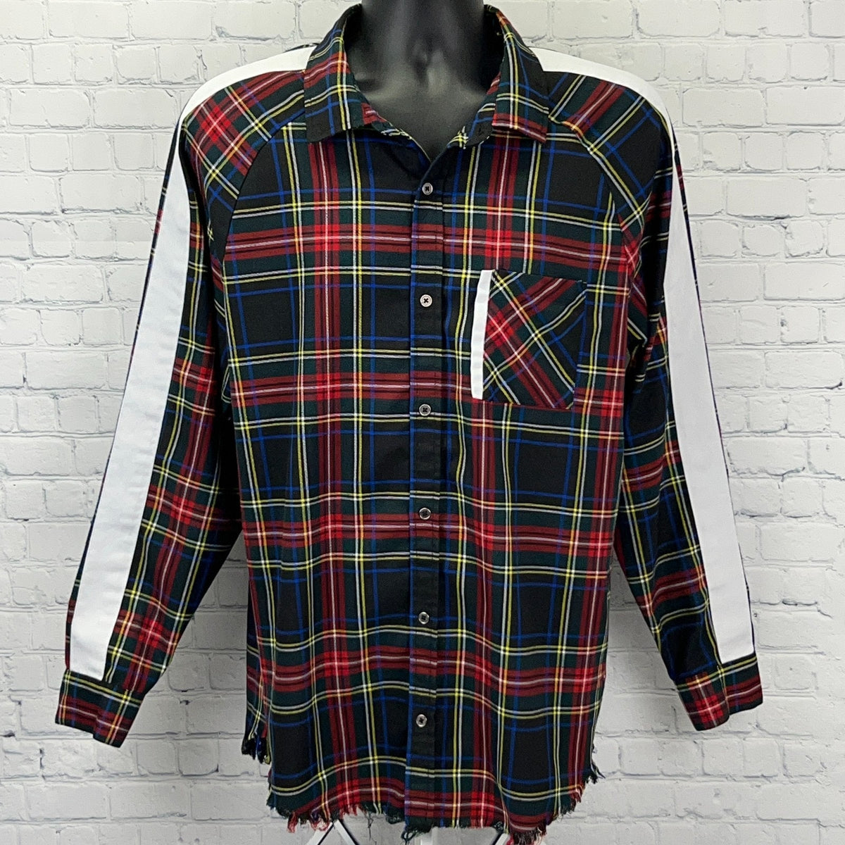 Elwood plaid button-up shirt in black, red, and blue with a chest pocket and unique side stripes