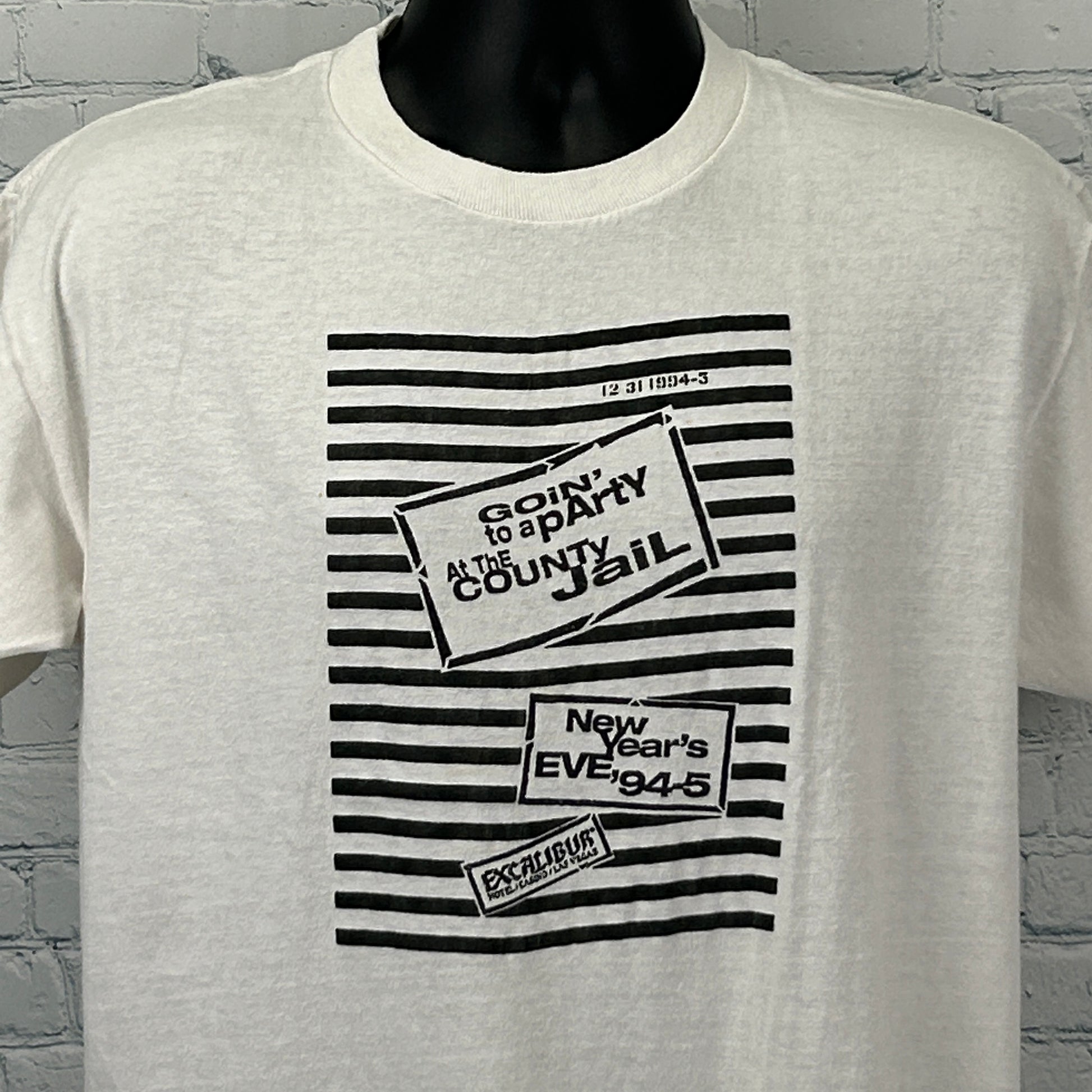 Vintage white T-shirt featuring Excalibur Las Vegas graphic with jail party theme, front view