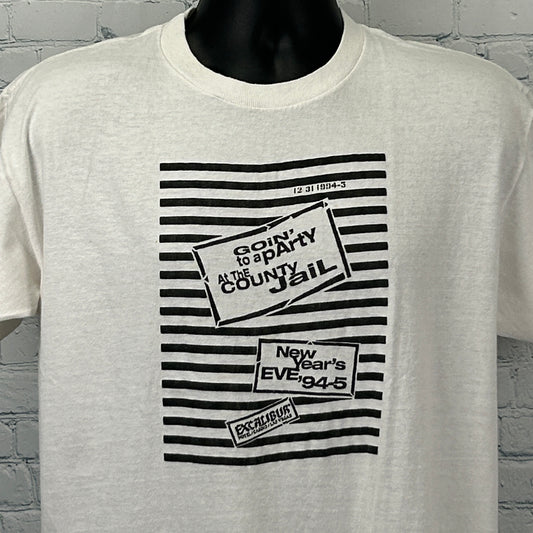 Vintage white T-shirt featuring Excalibur Las Vegas graphic with jail party theme, front view