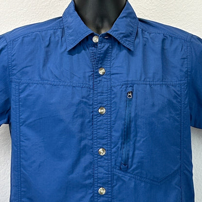 Front view of ExOfficio Shirt in blue, featuring a chest pocket and silver buttons