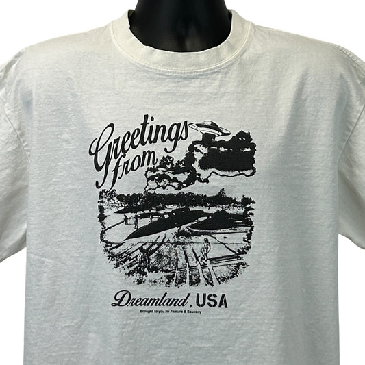 Feature Saucony Graphic T-Shirt in White, Front View with 'Greetings from Dreamland, USA' Print