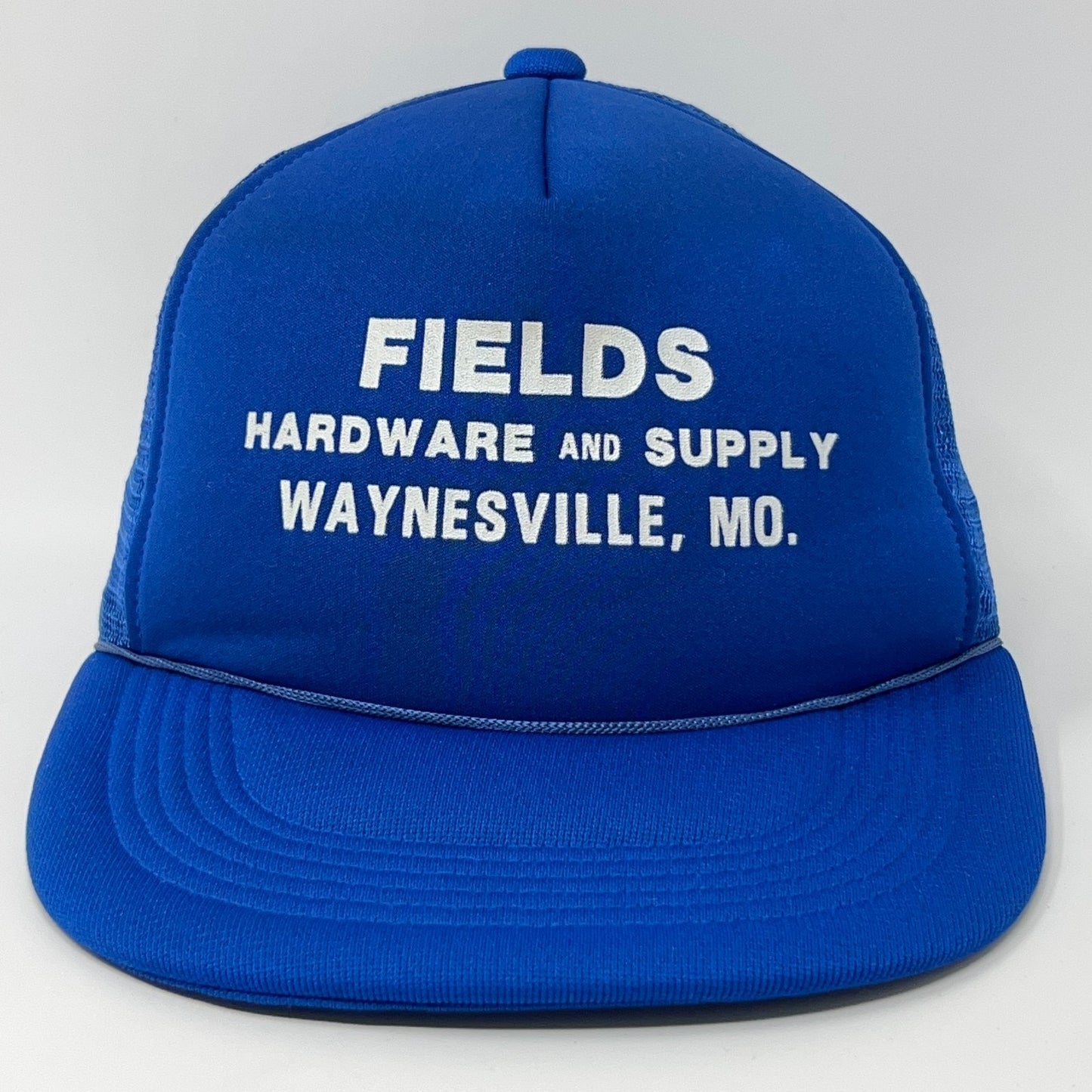 Front view of a blue Vintage Trucker Hat with white text Fields Hardware and Supply Waynesville, MO