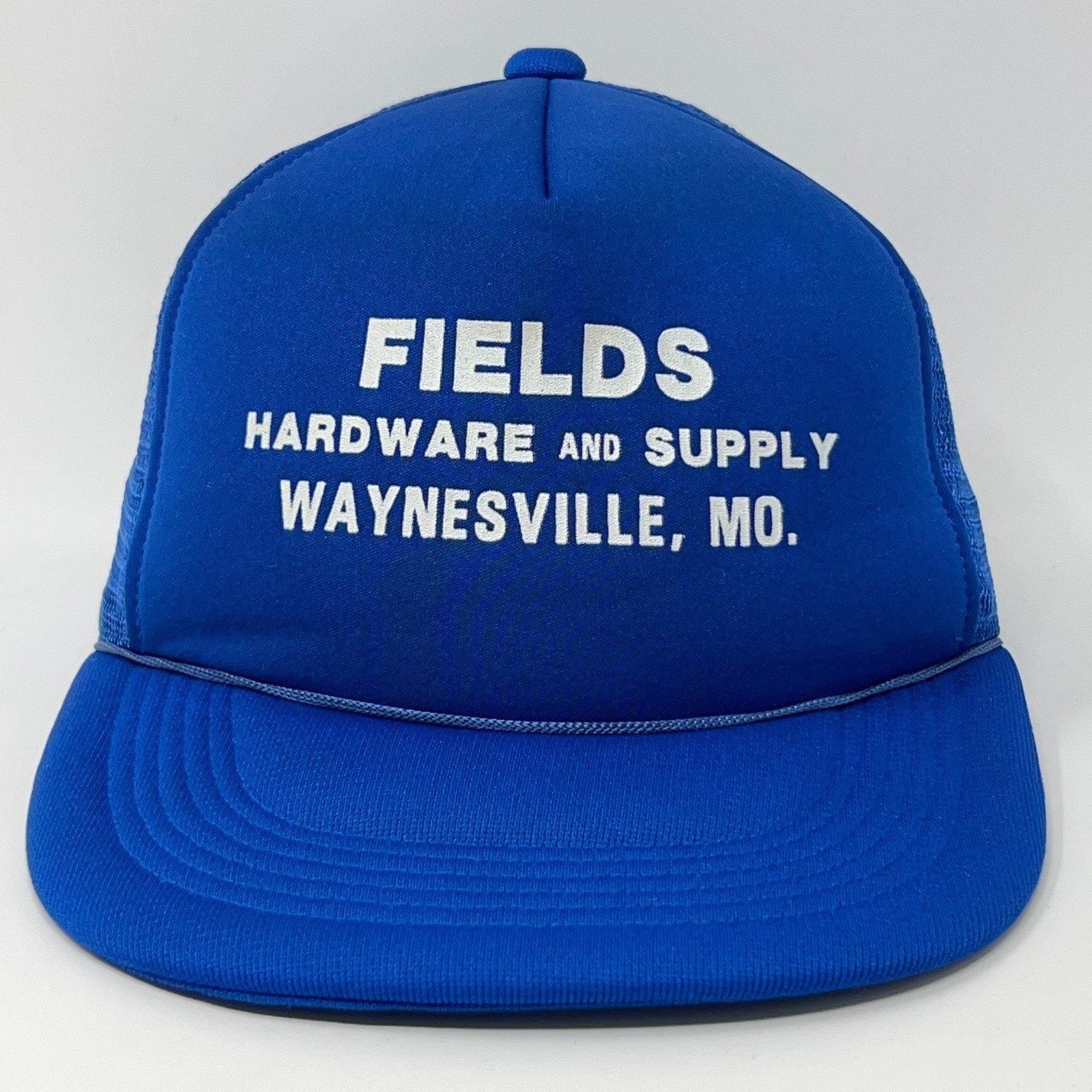 Front view of a blue Vintage Trucker Hat with white text Fields Hardware and Supply Waynesville, MO