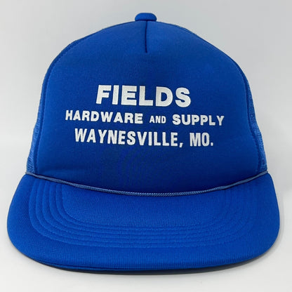 Front view of a blue Vintage Trucker Hat with white text Fields Hardware and Supply Waynesville, MO
