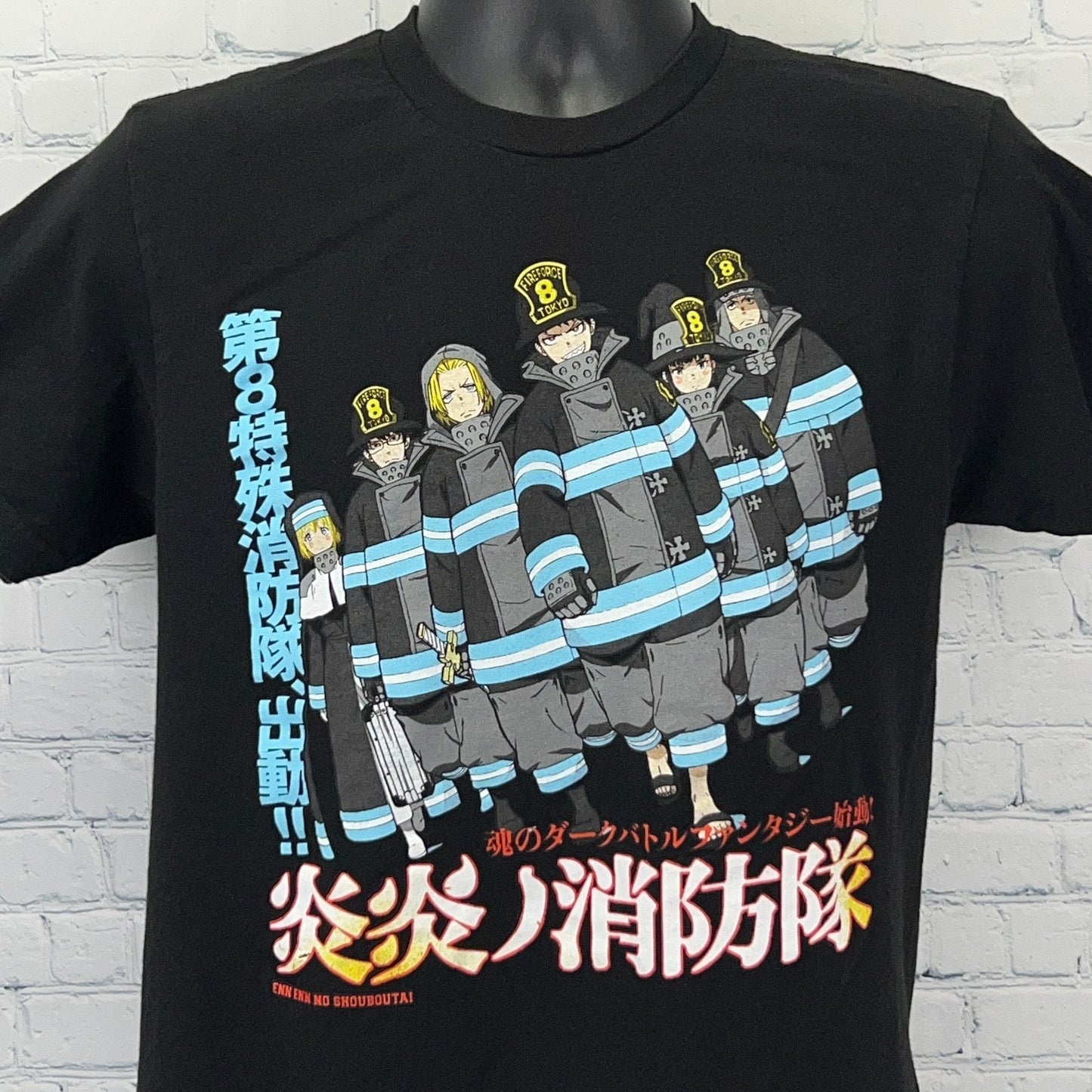 Fire Force black t-shirt featuring crew of firefighters in blue uniforms on the front, vibrant graphic design