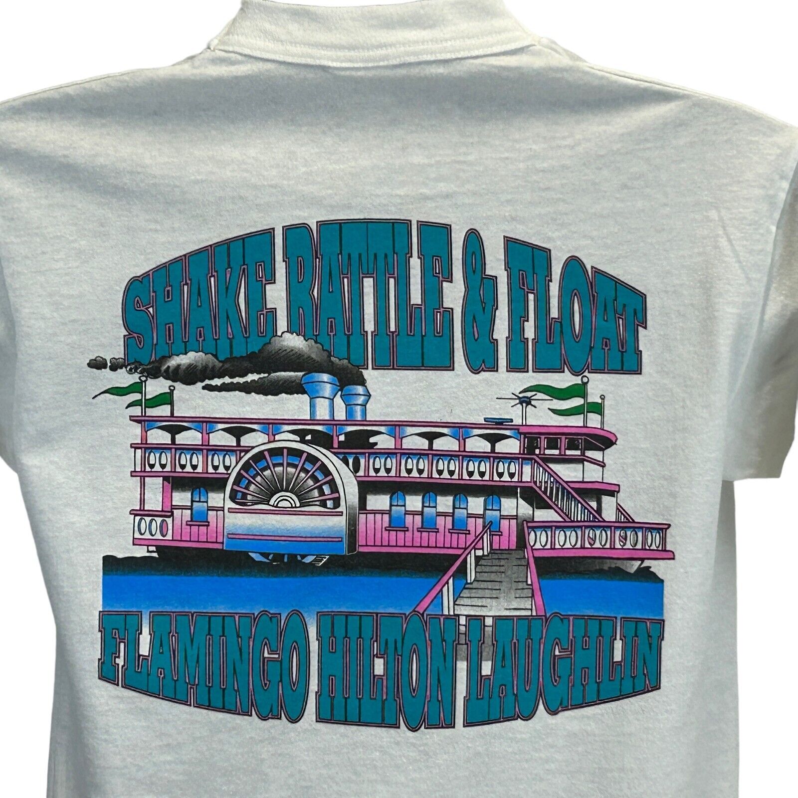 Light gray T-shirt with colorful graphic of a riverboat and text Flamingo Hilton Laughlin on the back