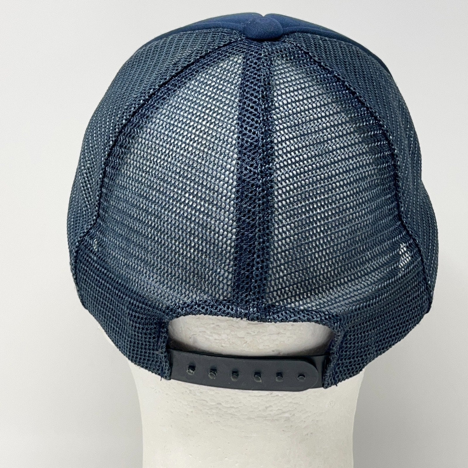 Vintage trucker cap hat in navy blue, back view, with adjustable strap