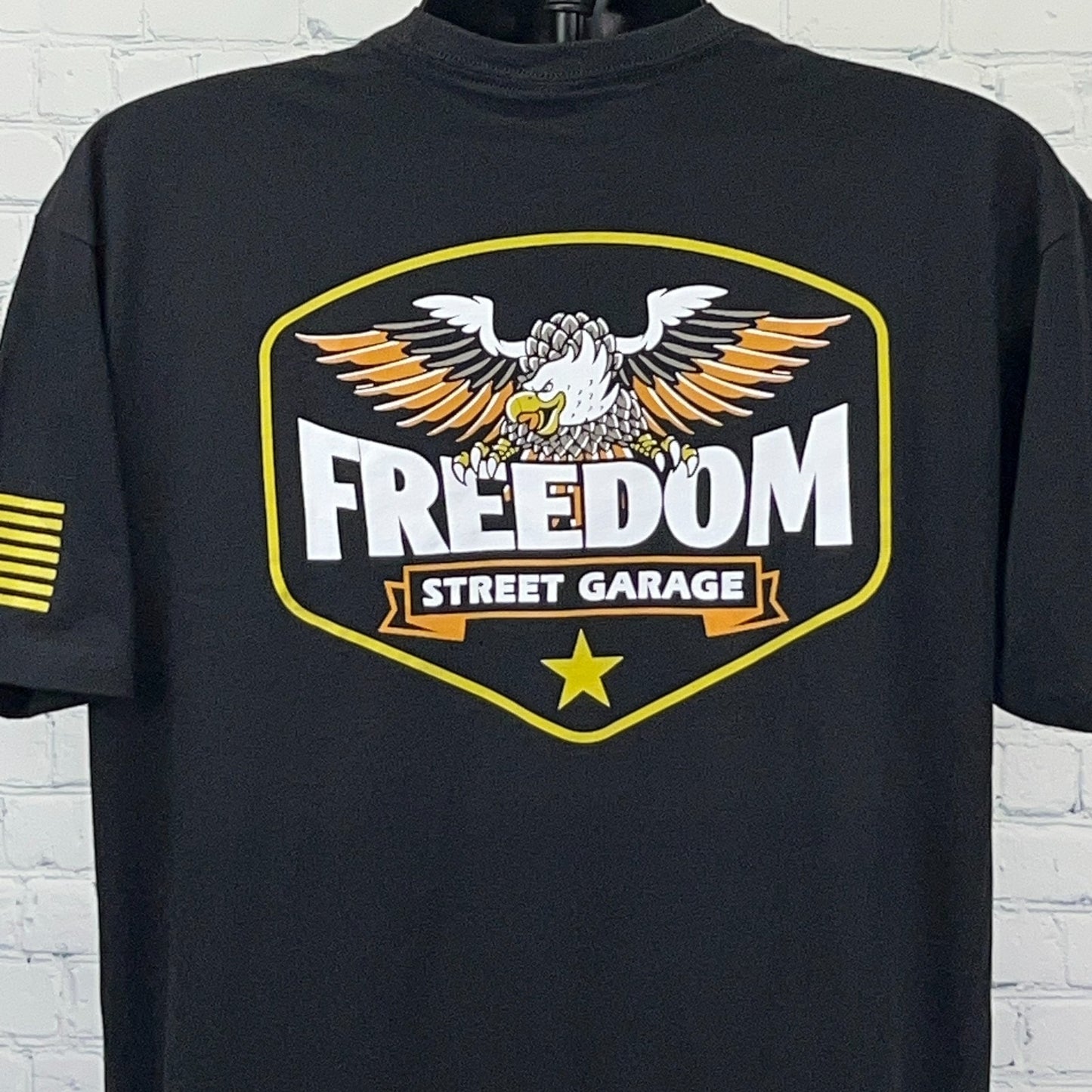 Black Freedom Street Garage T-shirt featuring eagle logo and bold graphic design on the front