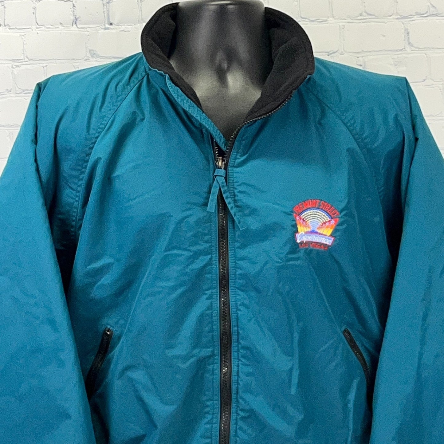 Vintage teal jacket featuring Fremont Street Experience logo on the front, zip closure, and stylish collar