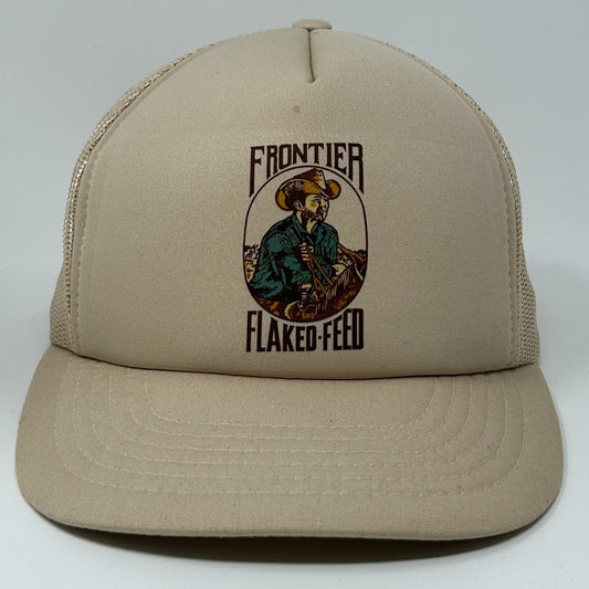 Tan Vintage Trucker Hat with a Front Logo of a Cowboy and Frontier Flaked Feed Design