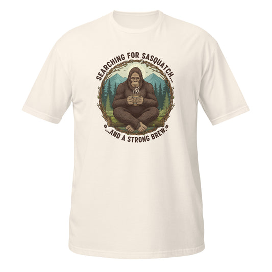 Funny T-Shirt in cream featuring Bigfoot graphic and 'Searching for Sasquatch' text on the front