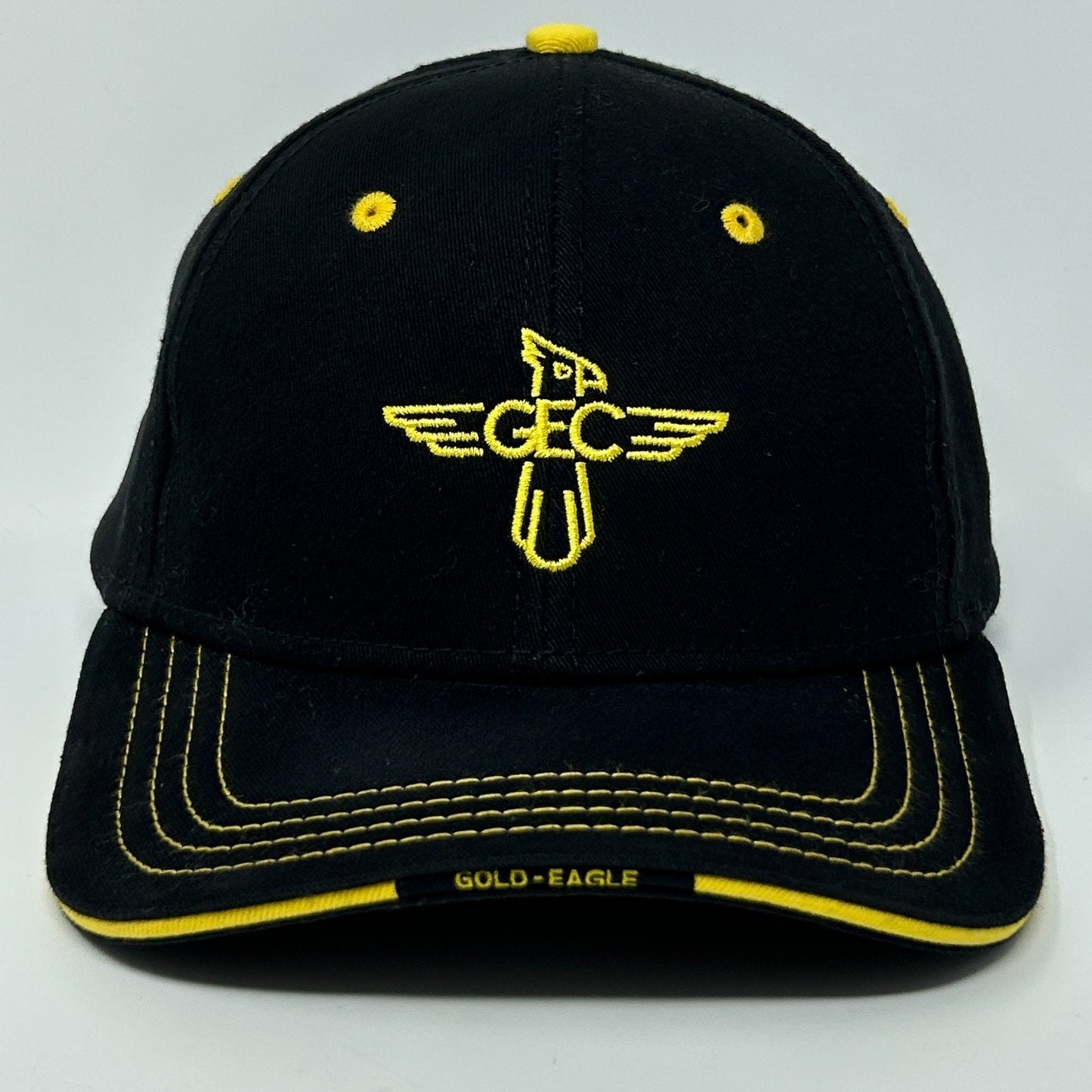 Front view of Gold Eagle Coop Hat in black with yellow accents and logo embroidery