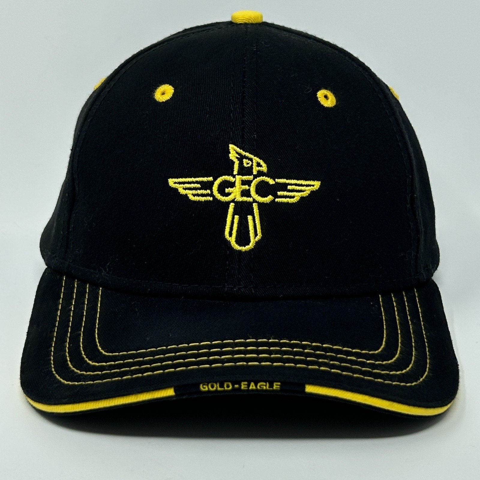 Front view of Gold Eagle Coop Hat in black with yellow accents and logo embroidery