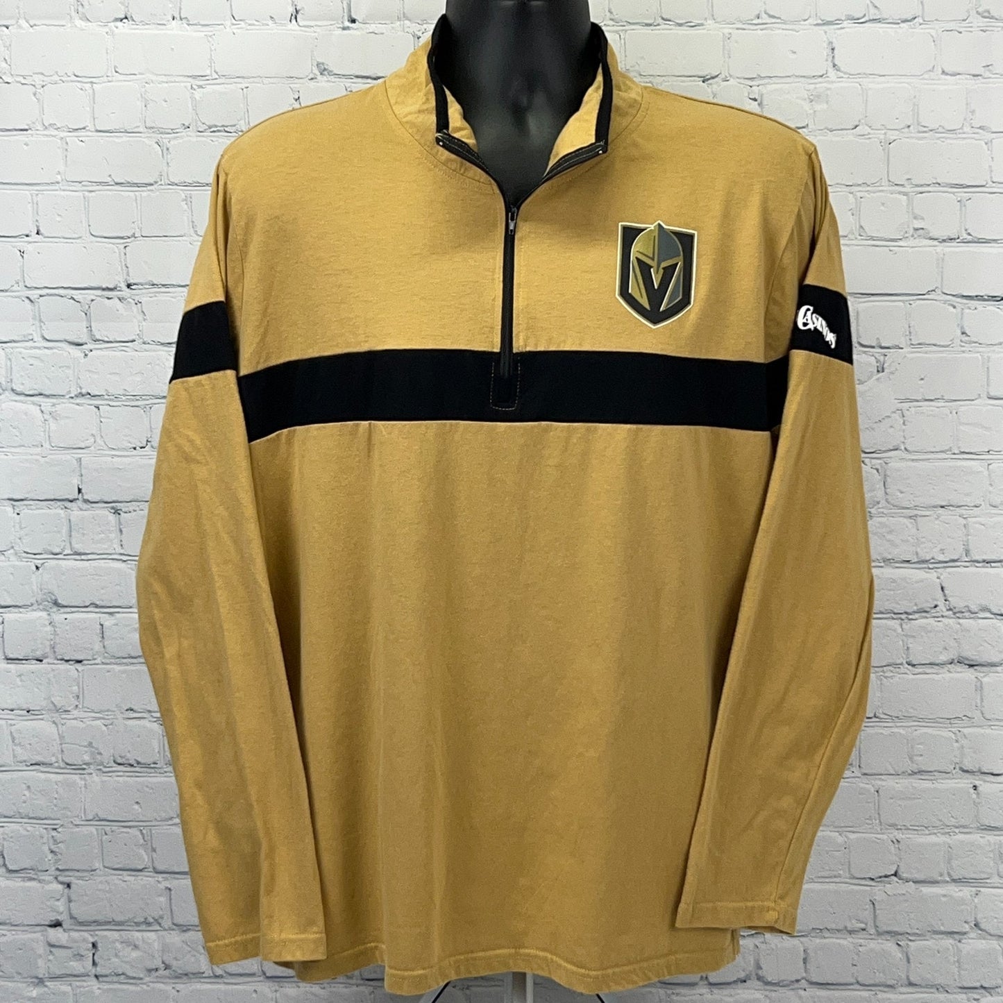 Gold long sleeve pullover with Golden Knights logo and black stripes, featuring a quarter-zip front
