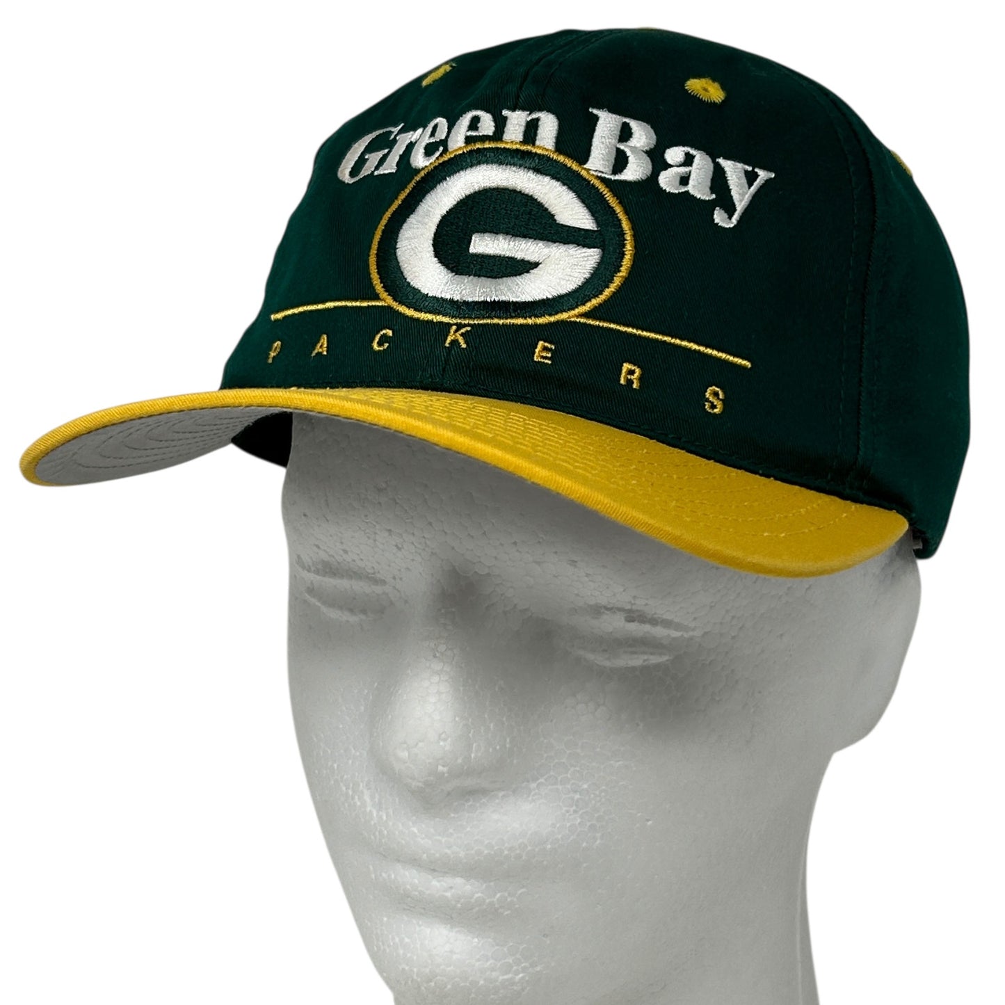 Front view of Green Bay Packers baseball cap in green and gold, featuring logo and team name