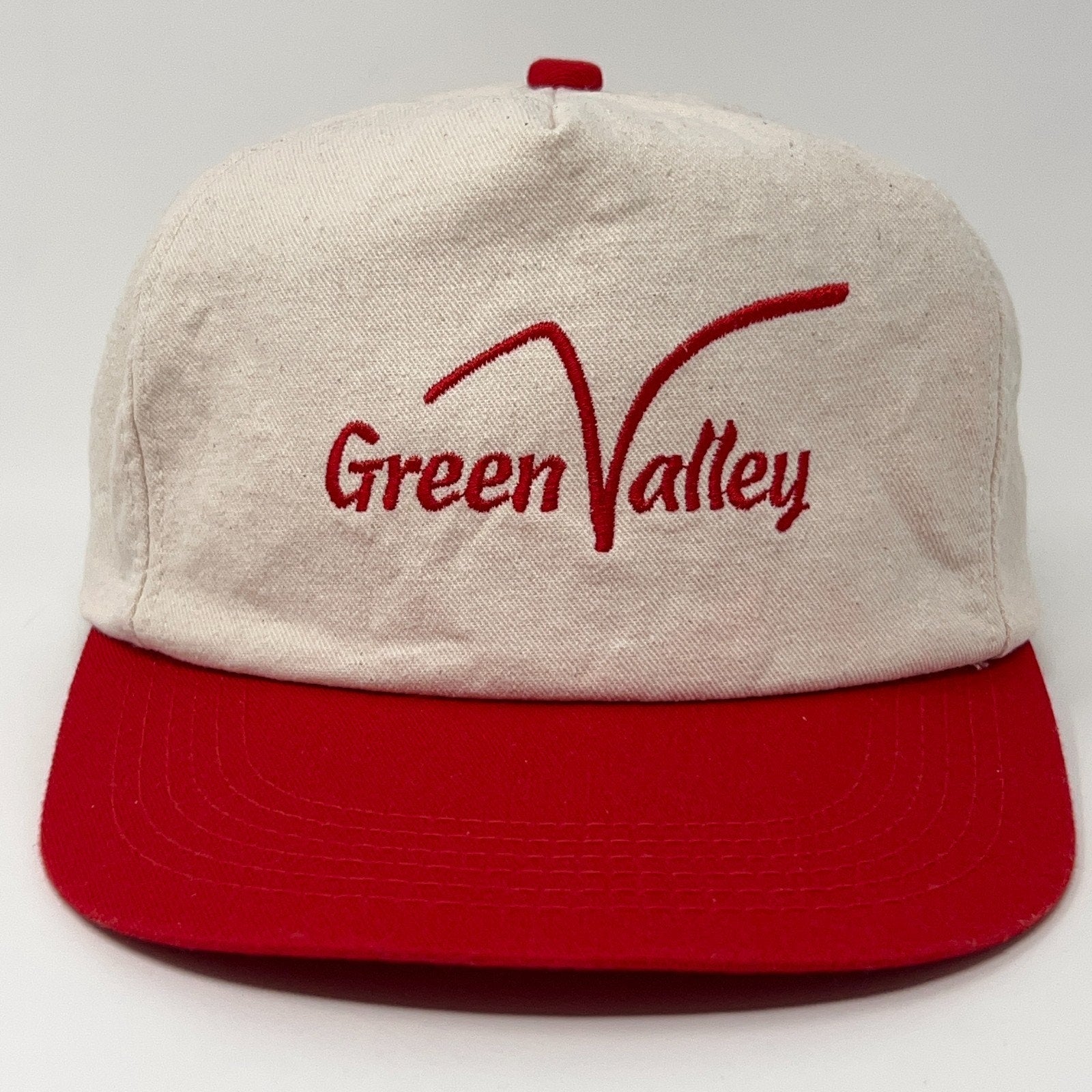 Red and beige cap featuring the Green Valley Golf Course logo on the front