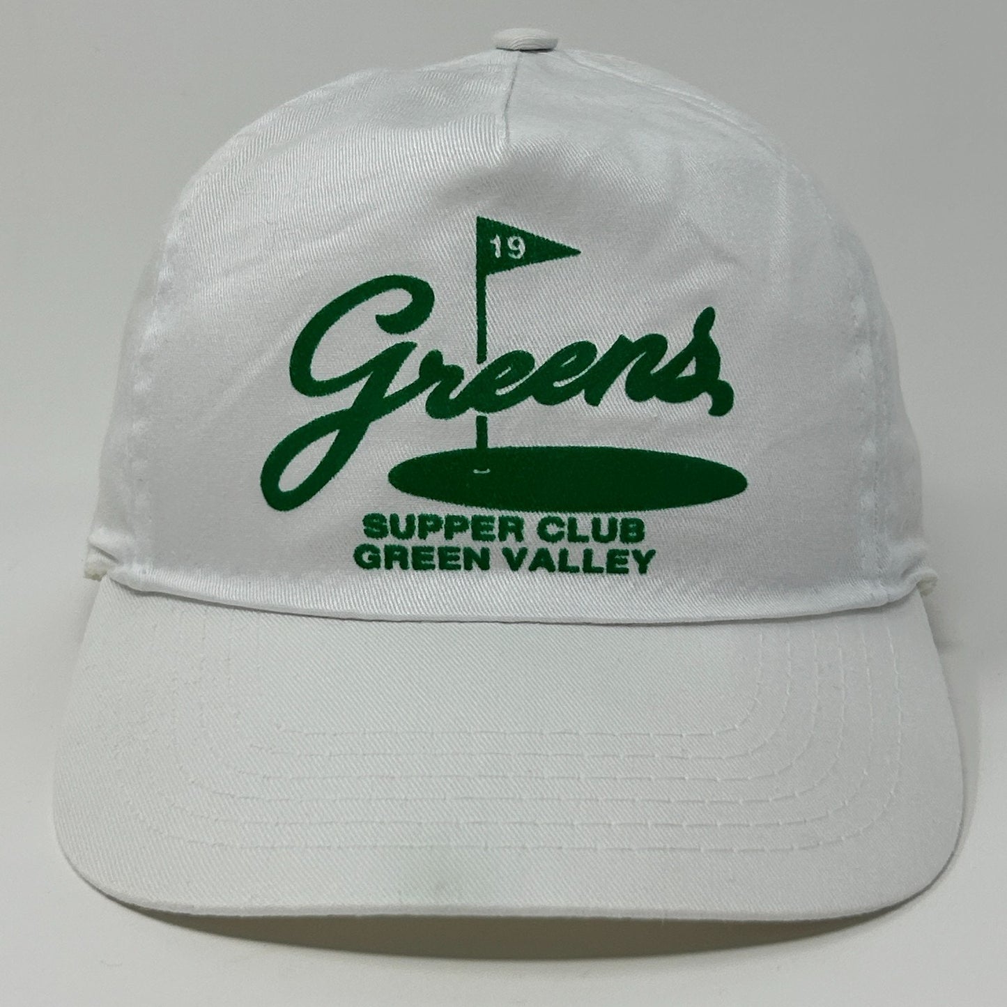 White vintage hat with Green Valley logo and green flag detail on the front
