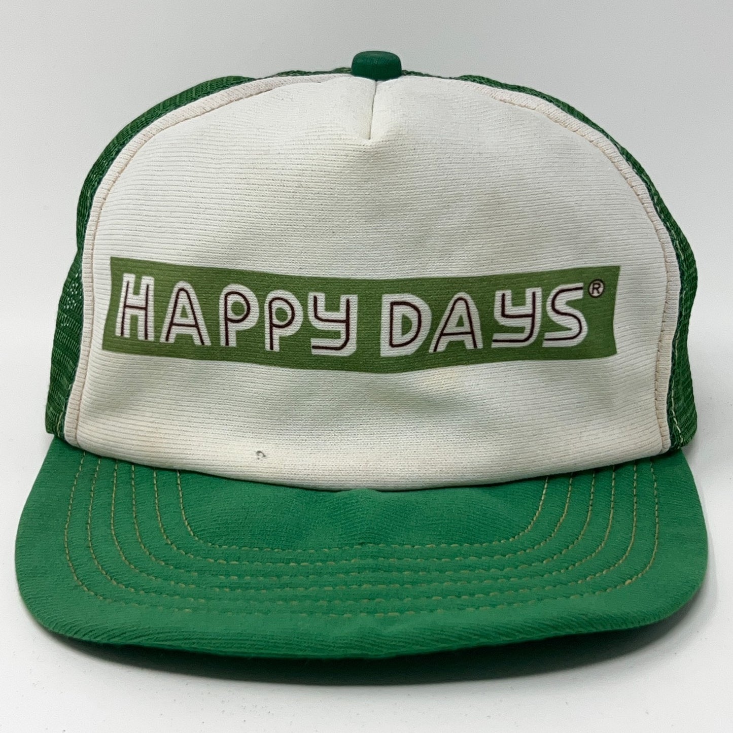 Vintage green trucker hat with 'HAPPY DAYS' logo on front, snapback closure, vibrant retro style