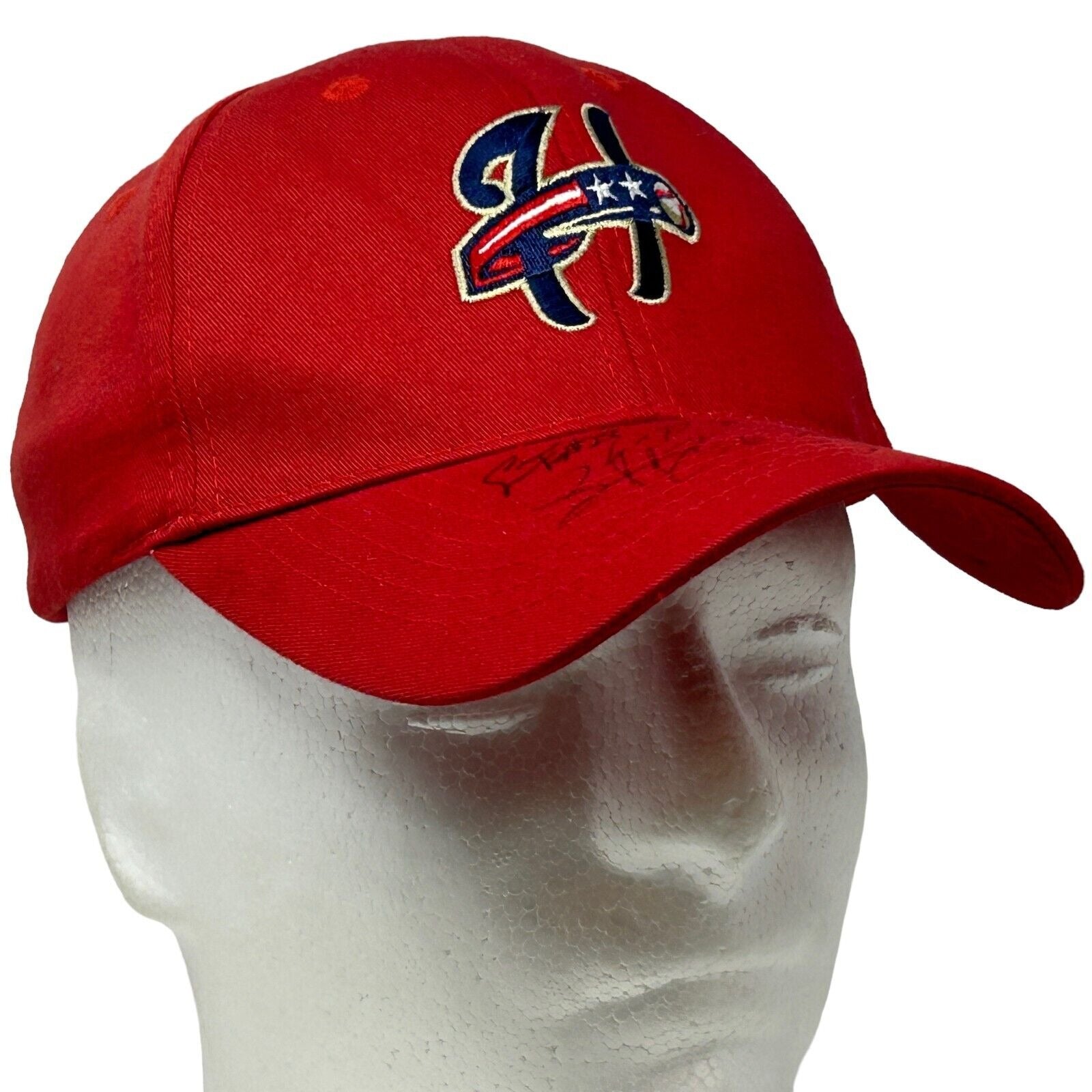 Red Harrisburg Senators baseball hat featuring an embroidered logo on the front with a signature detail.
