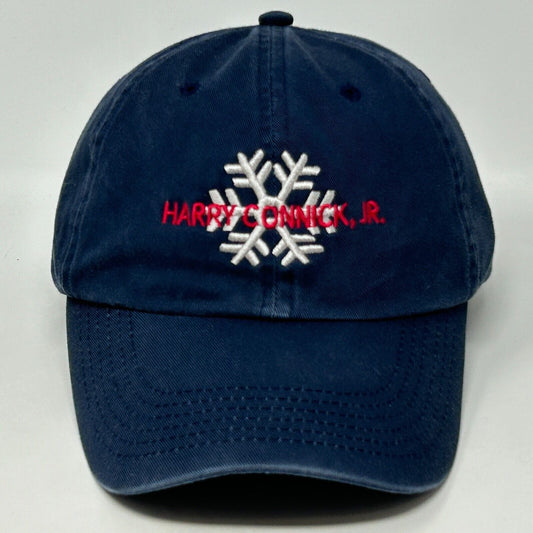 Front view of navy Art Headwear hat featuring Harry Connick Jr. embroidered with a snowflake design