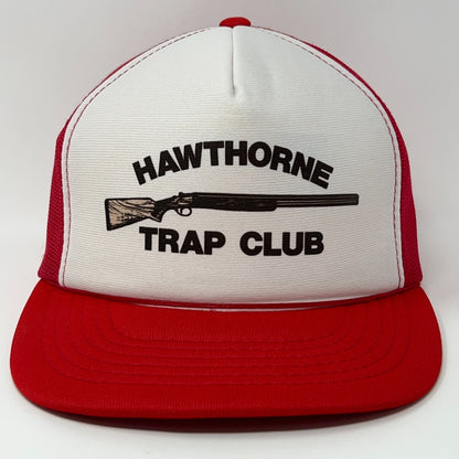 Front view of a red and white trucker cap hat featuring Hawthorne Trap Club logo with a shotgun graphic