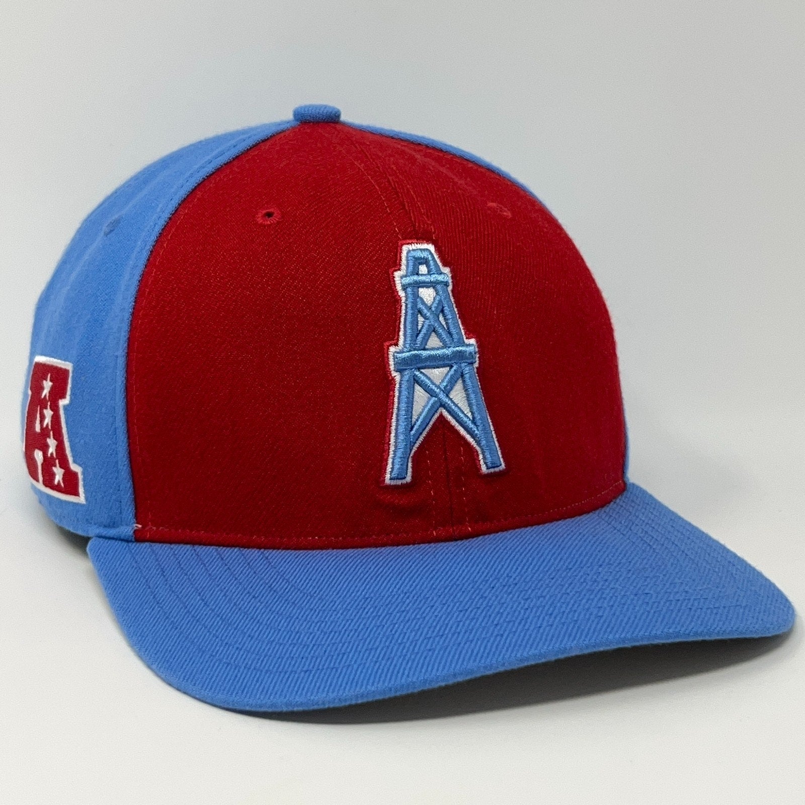 Red and blue Houston Oilers cap featuring a prominent oil tower logo on the front