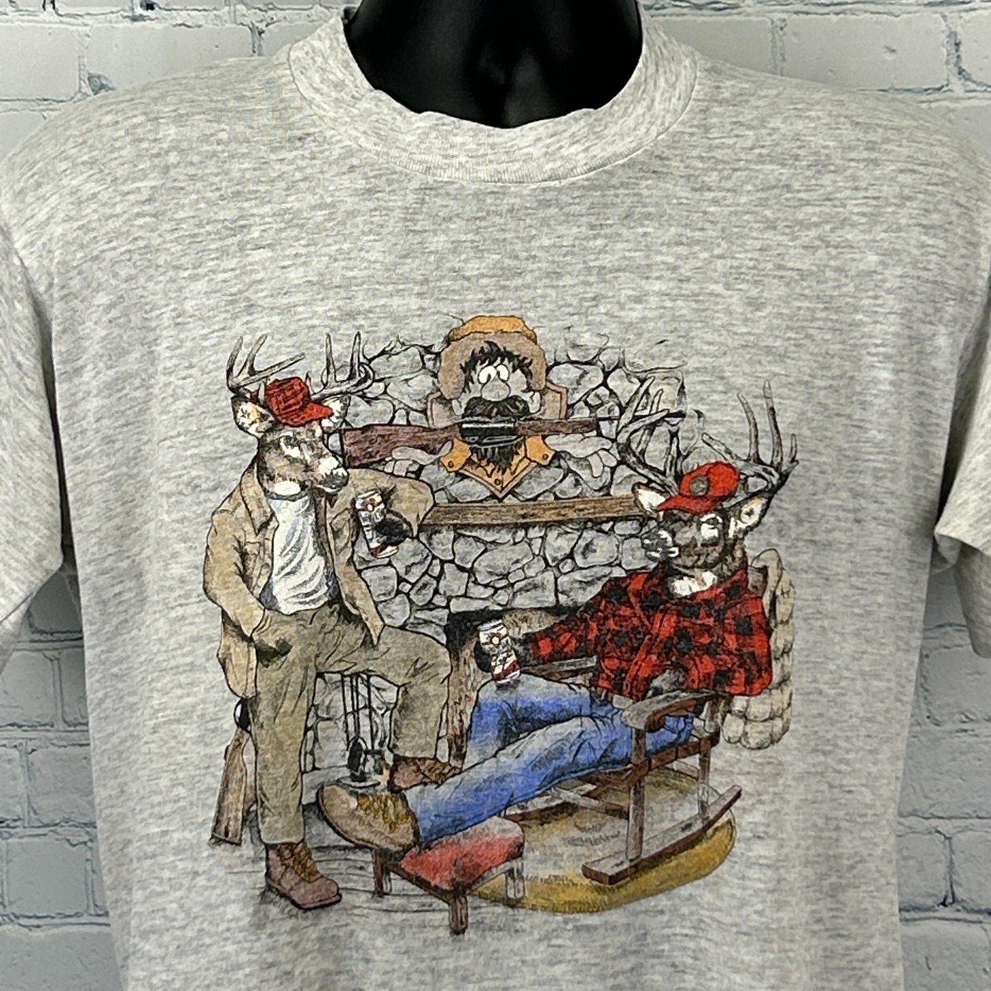 Gray Jerzees Hunter T Shirt featuring a front graphic of two deer in flannel attire by a fireplace
