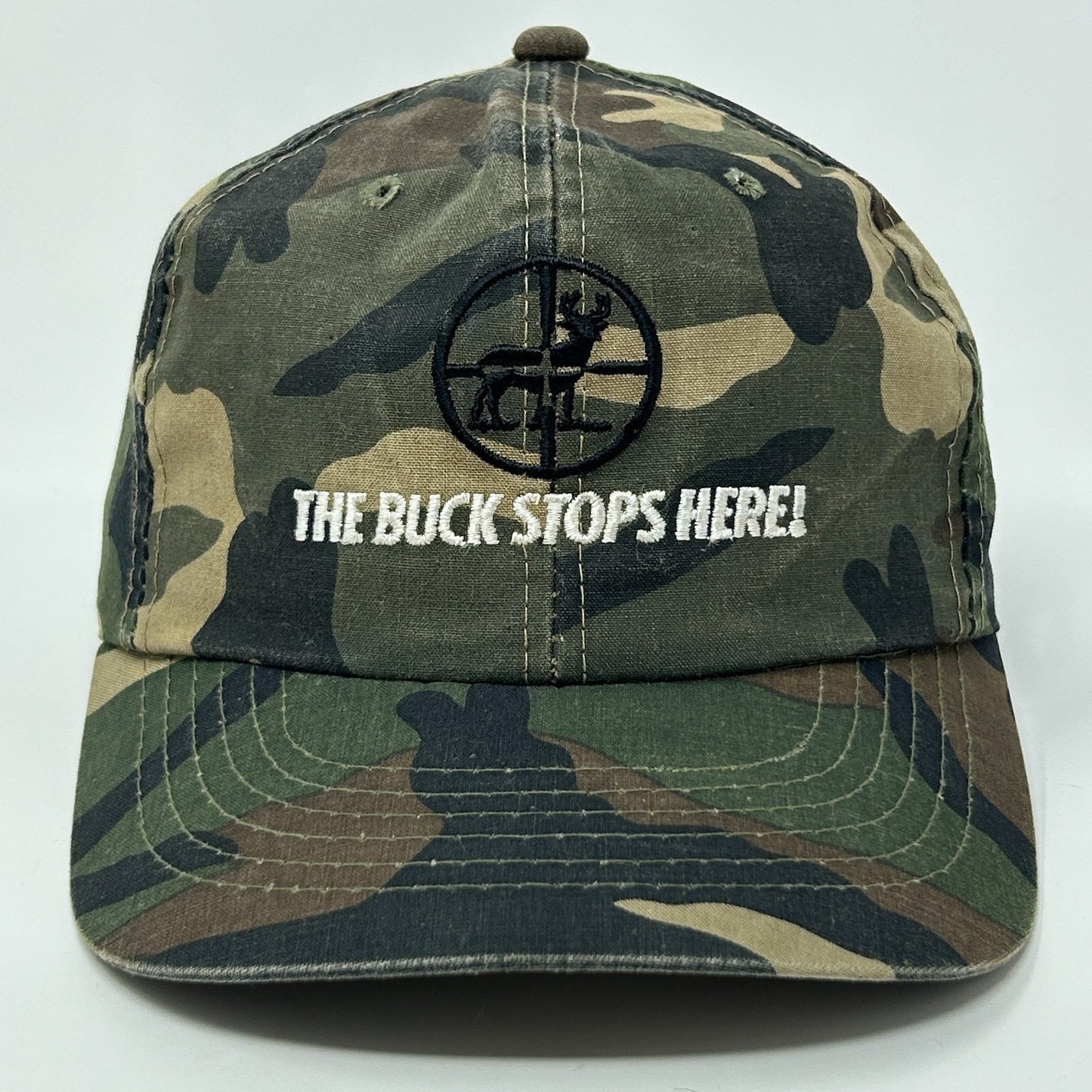 Vintage camo hunting hat featuring a logo and 'The Buck Stops Here' embroidered on the front