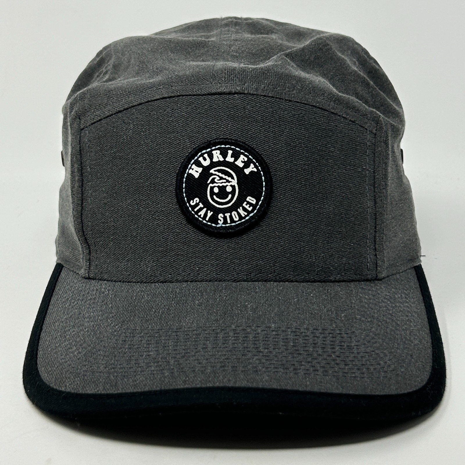 Front view of a gray Hurley Hat featuring a round logo patch with 'Stay Stoked' text.