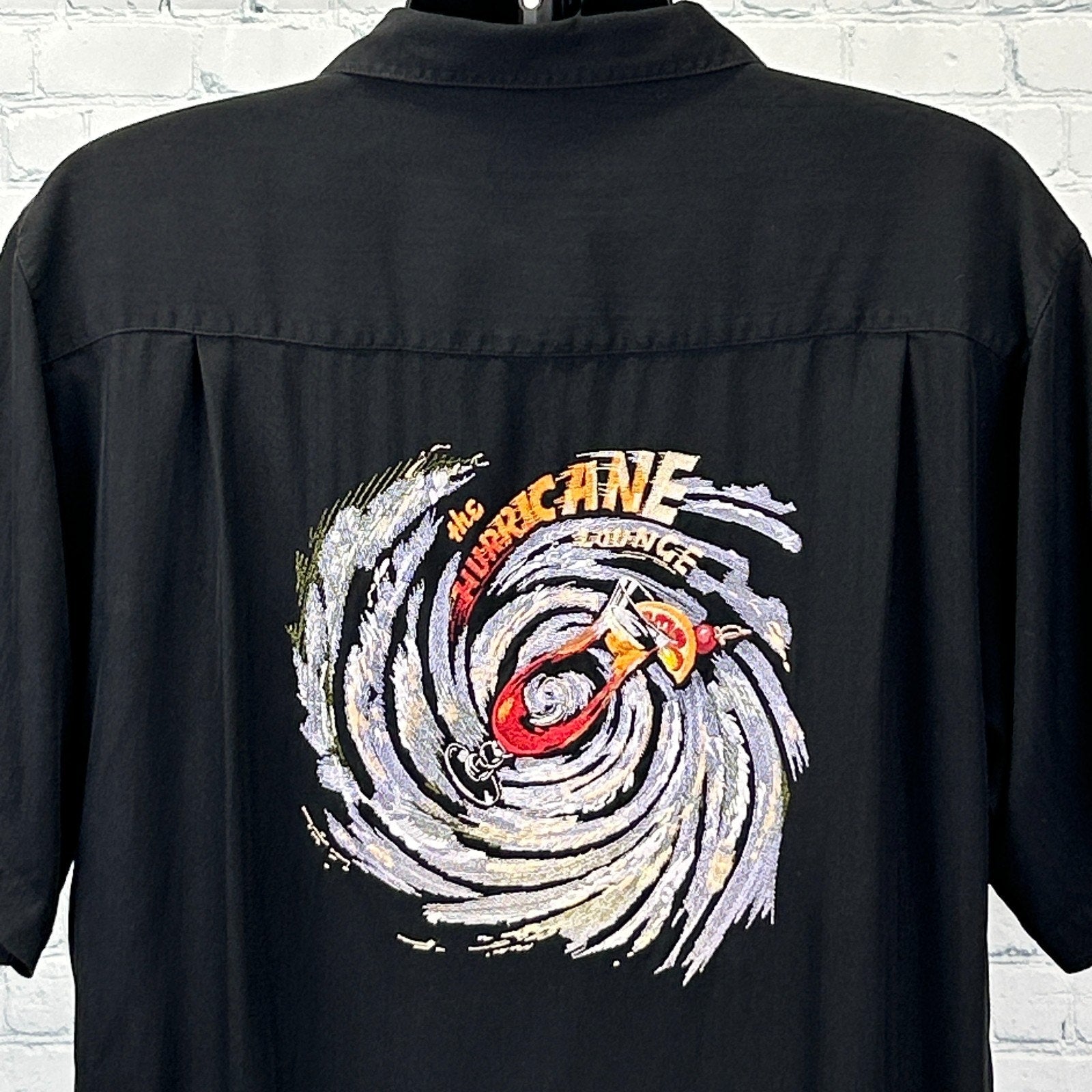 Black Hawaiian Shirt by Luau featuring vibrant hurricane graphic on back in large size