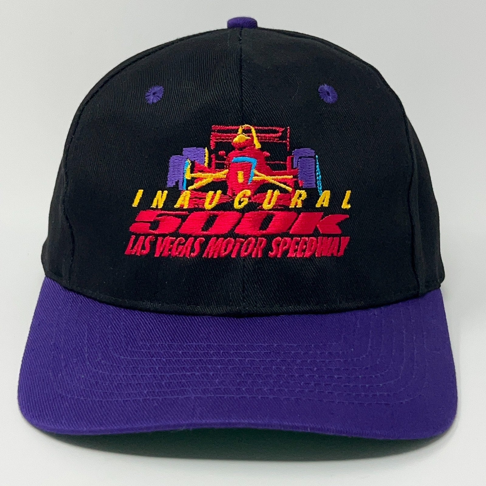 Black IndyCar cap with purple brim featuring colorful inaugural race logo from Las Vegas Motor Speedway