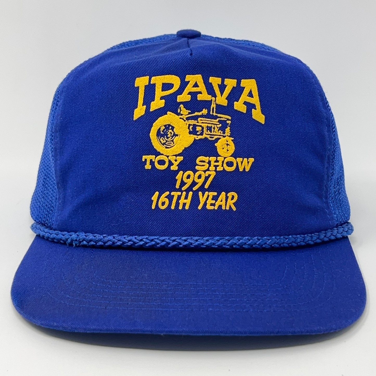 Vintage blue baseball hat with yellow IPAVA Toy Show 1997 logo and braided brim detail