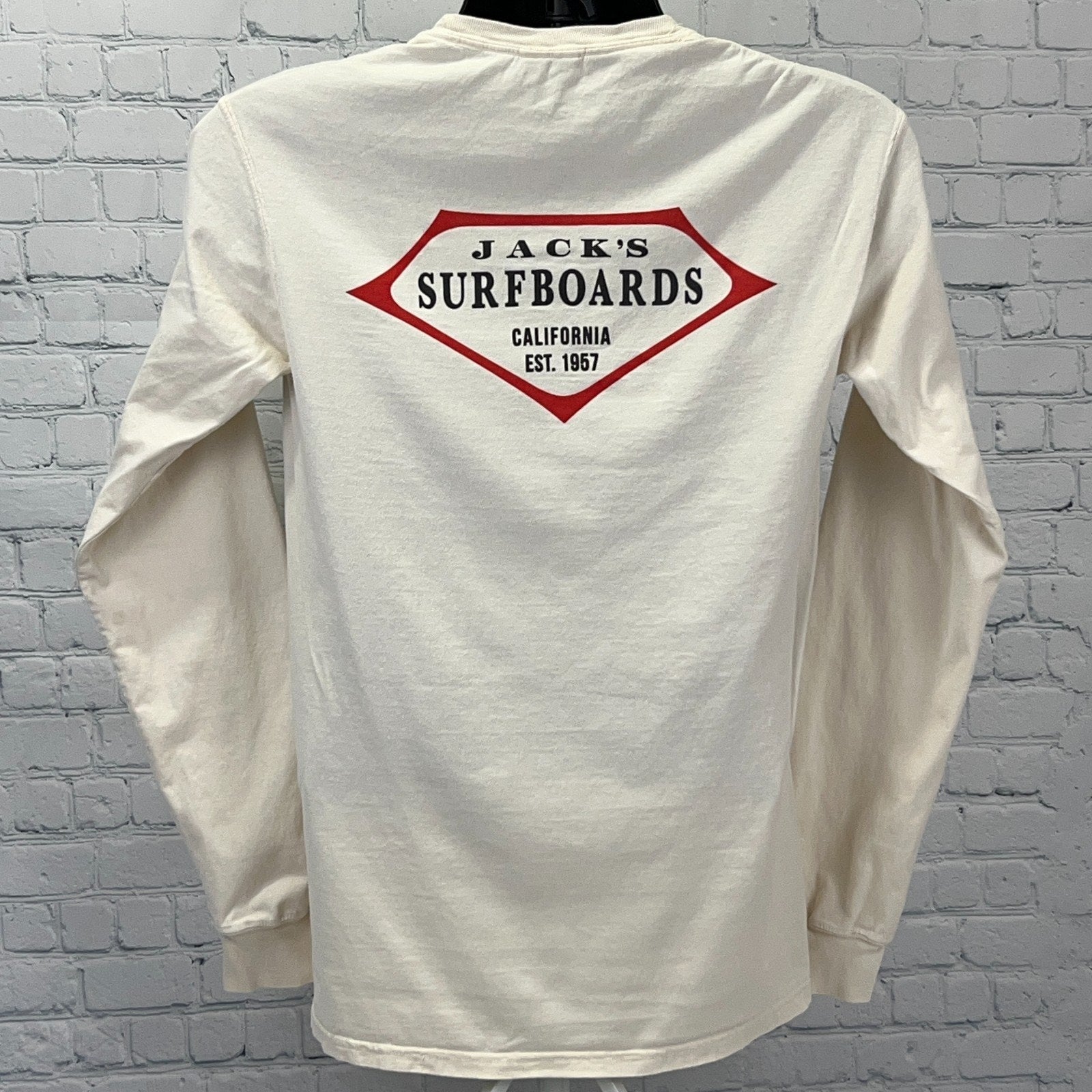 Back view of Jack's Surfboards long sleeve cream t-shirt featuring red logo and established year 1967