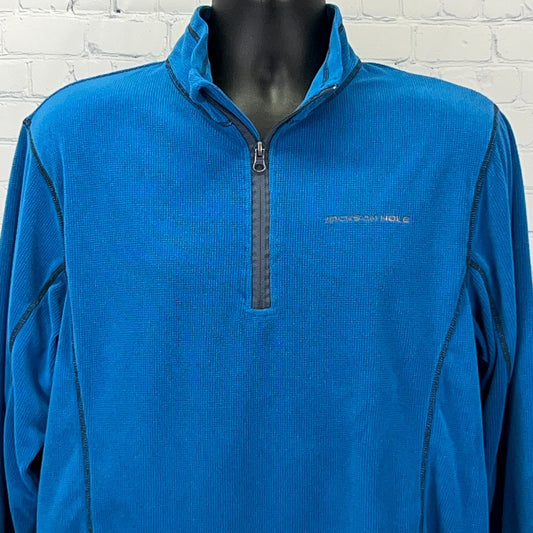 Front view of blue Jackson Hole pullover with half zip and logo on collar, ideal for outdoor activities.