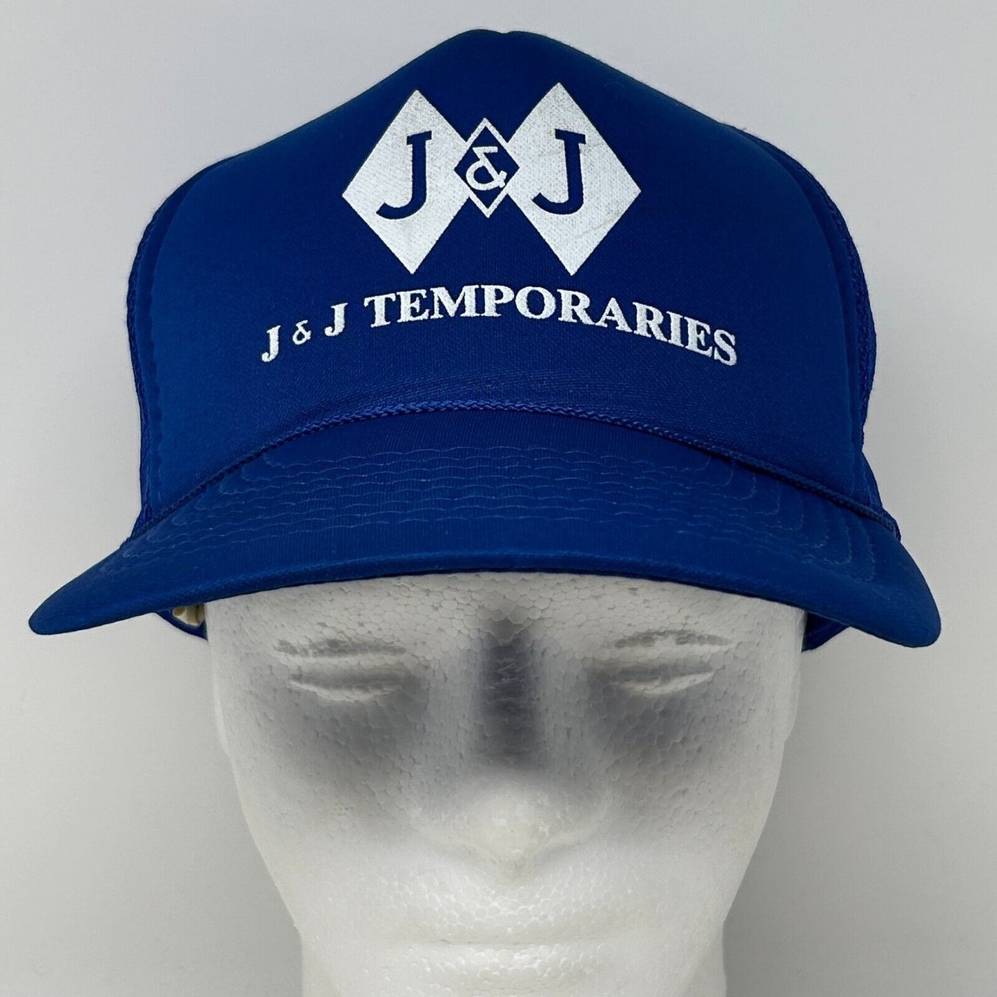 Front view of a blue Vintage cap featuring J & J TEMPORARIES logo in white