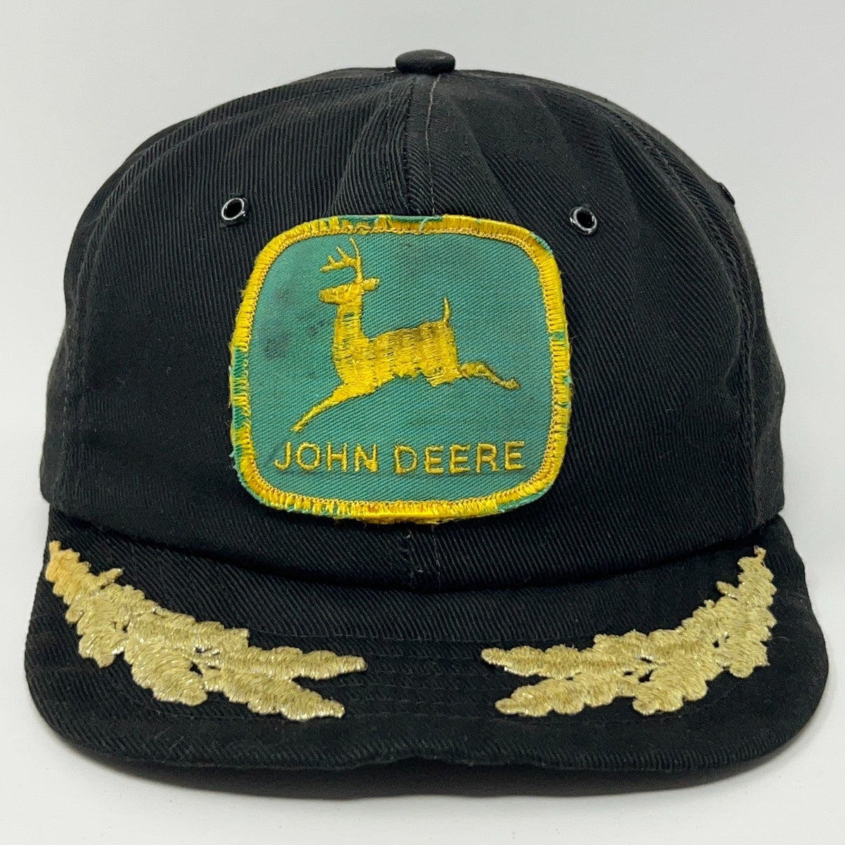John Deere black cap with a vintage logo patch and gold embroidery detailing