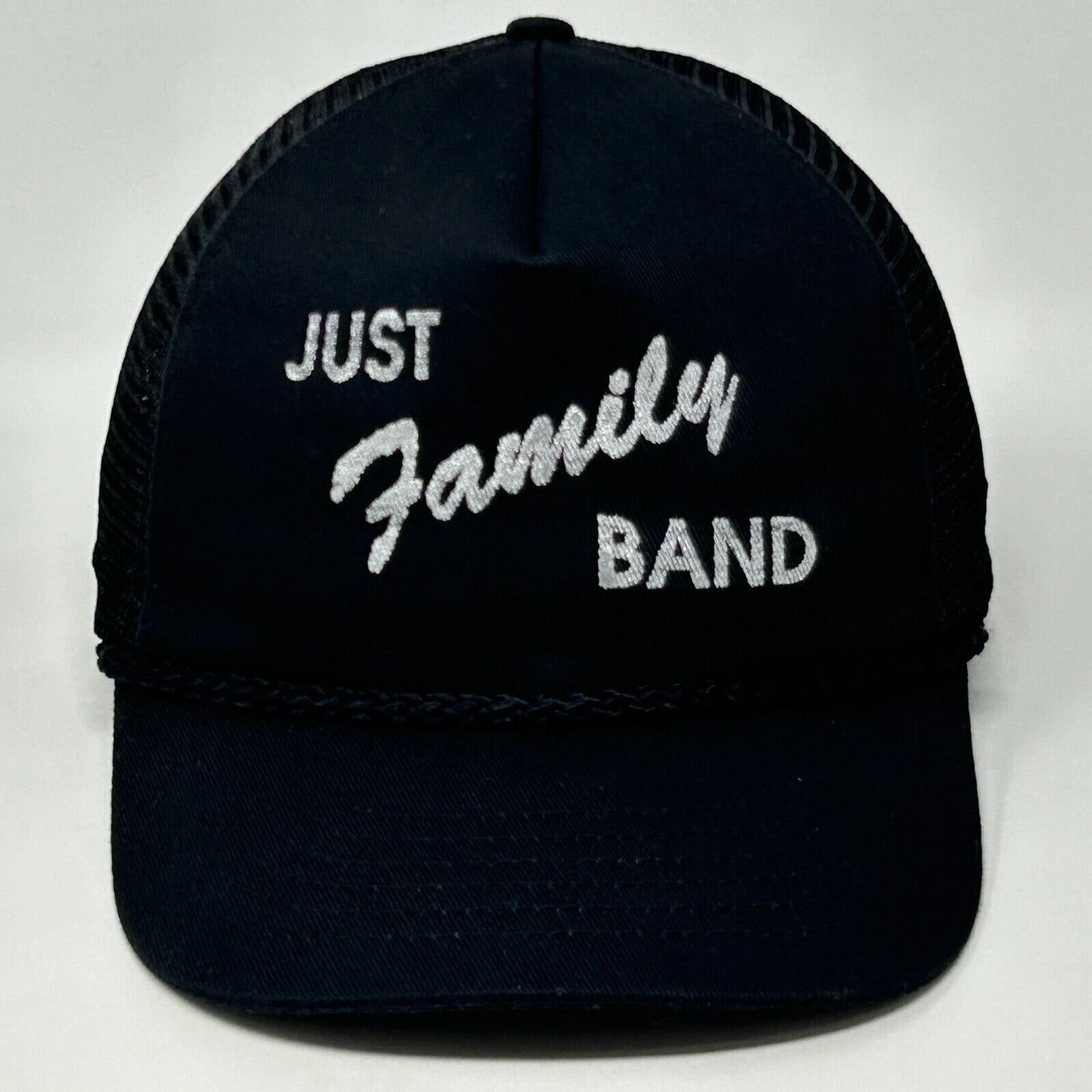 Front view of a black Vintage trucker hat with Just Family Band logo in white