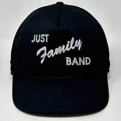 Front view of a black Vintage trucker hat with Just Family Band logo in white