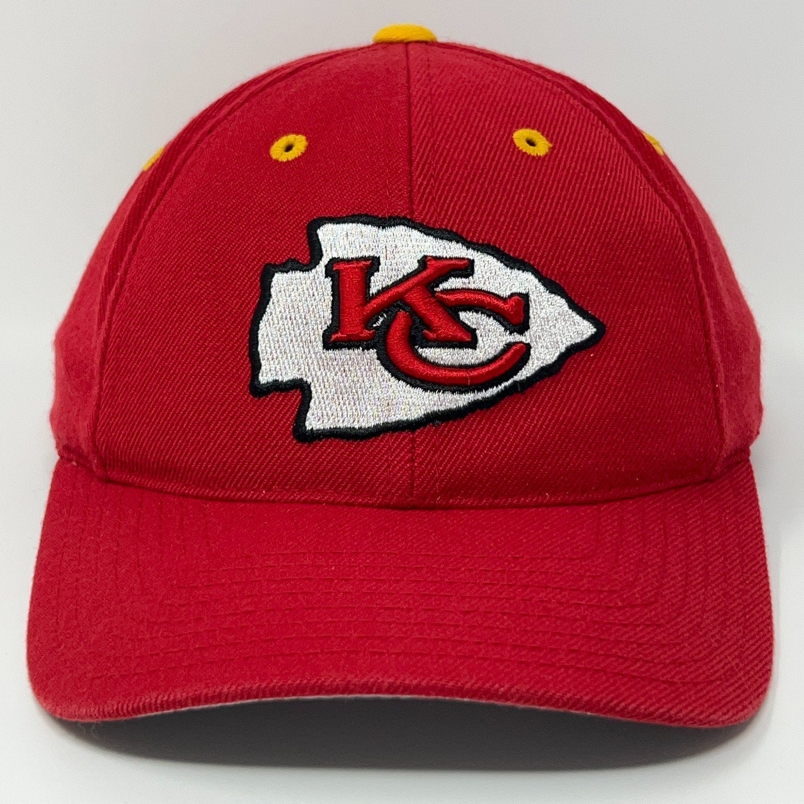 Red Kansas City Chiefs baseball cap with embroidered logo on front and yellow eyelets