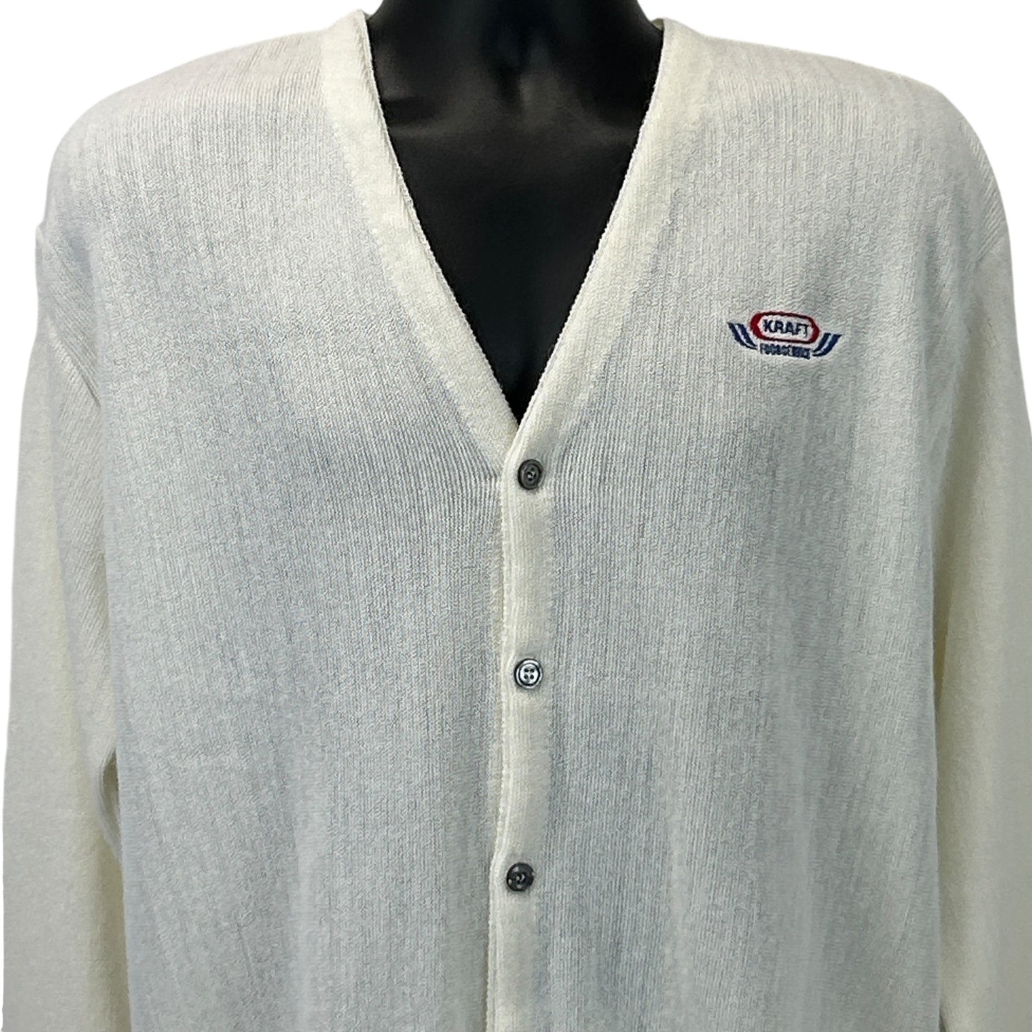 Front view of Pinnacle Kraft Sweater in cream with logo patch and button closure