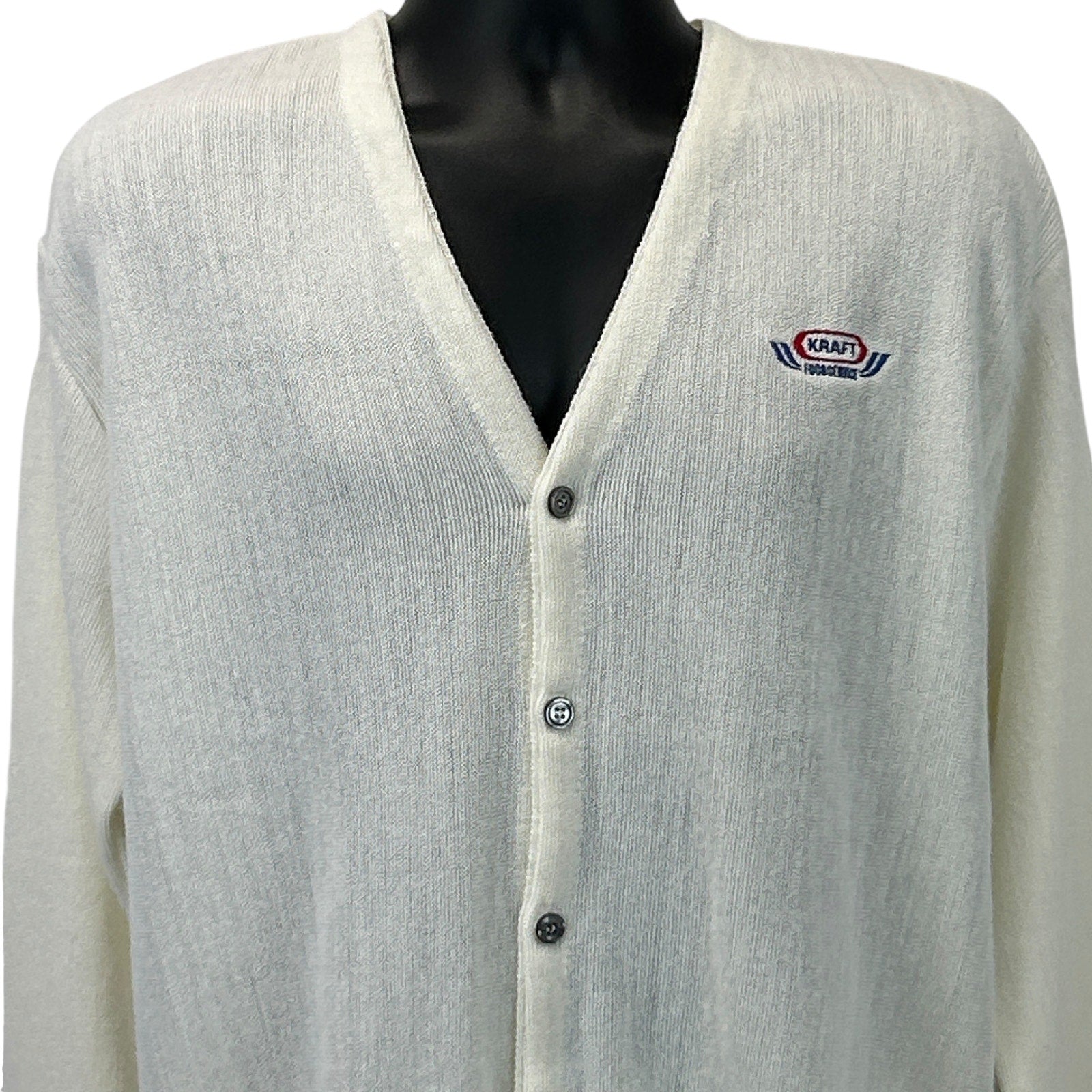 Front view of Pinnacle Kraft Sweater in cream with logo patch and button closure