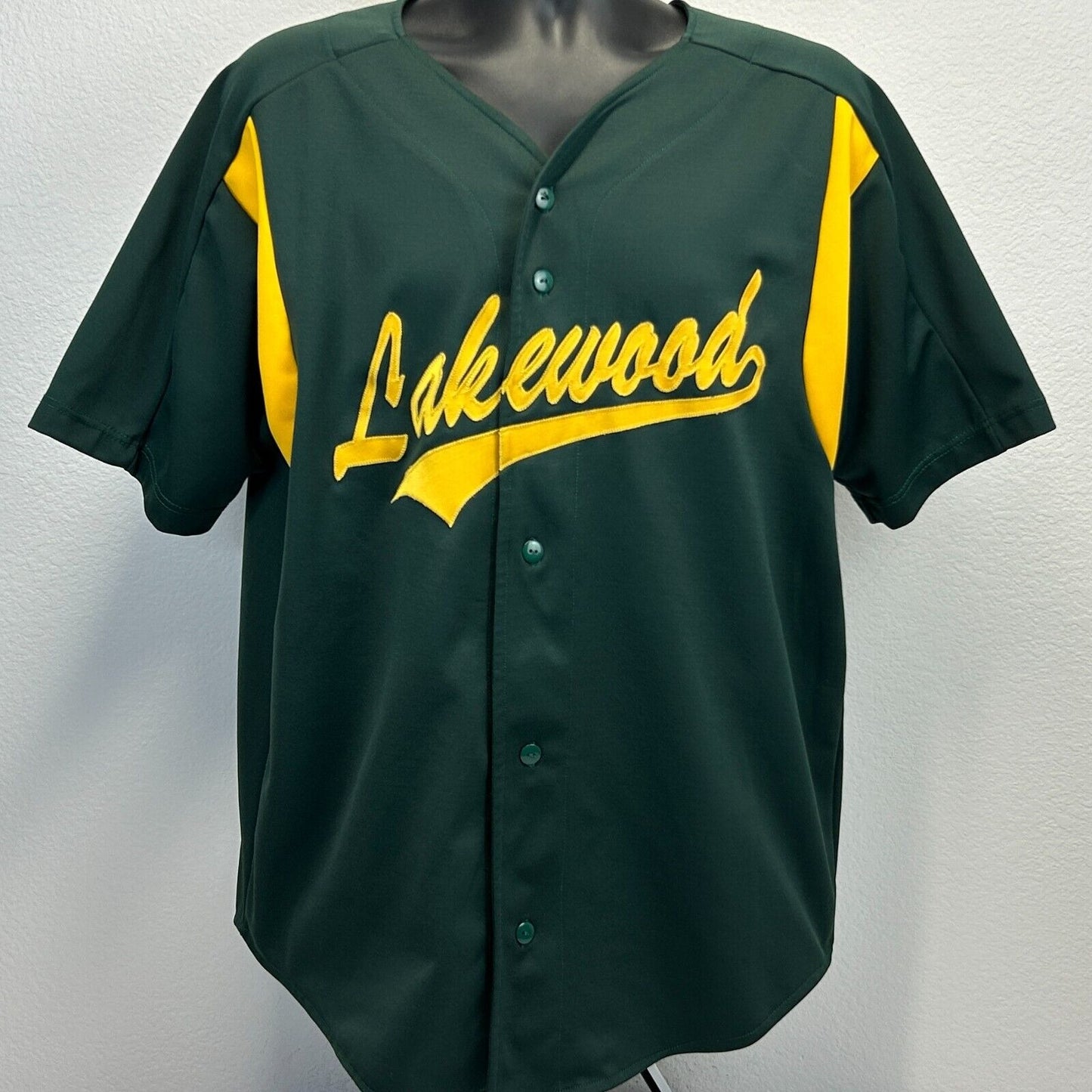 Front view of Lakewood jersey in dark green and yellow with logo detail and button closure