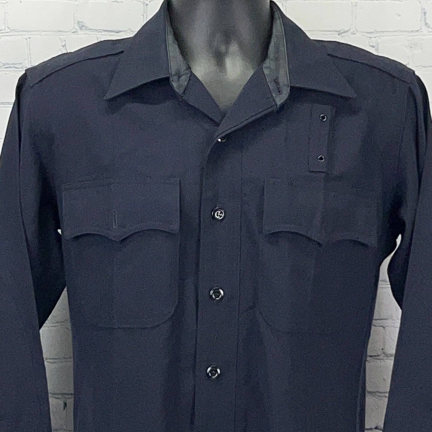 Vintage navy blue LAPD uniform shirt featuring two front pockets and a collar in a detailed front view