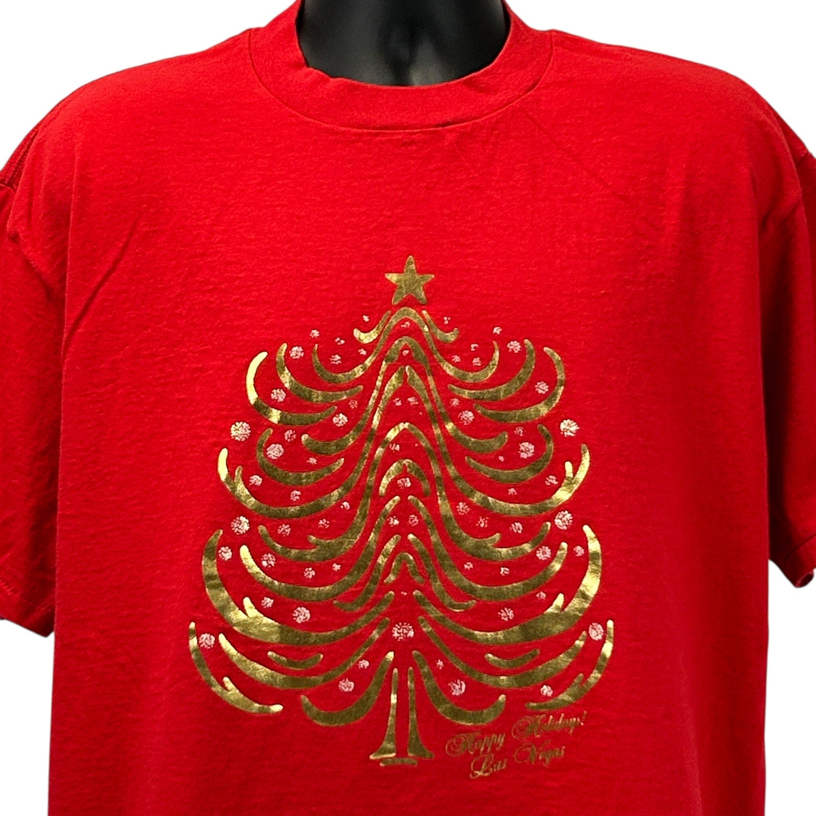 Red Delta T-Shirt featuring a gold Christmas tree design for Las Vegas Christmas celebrations