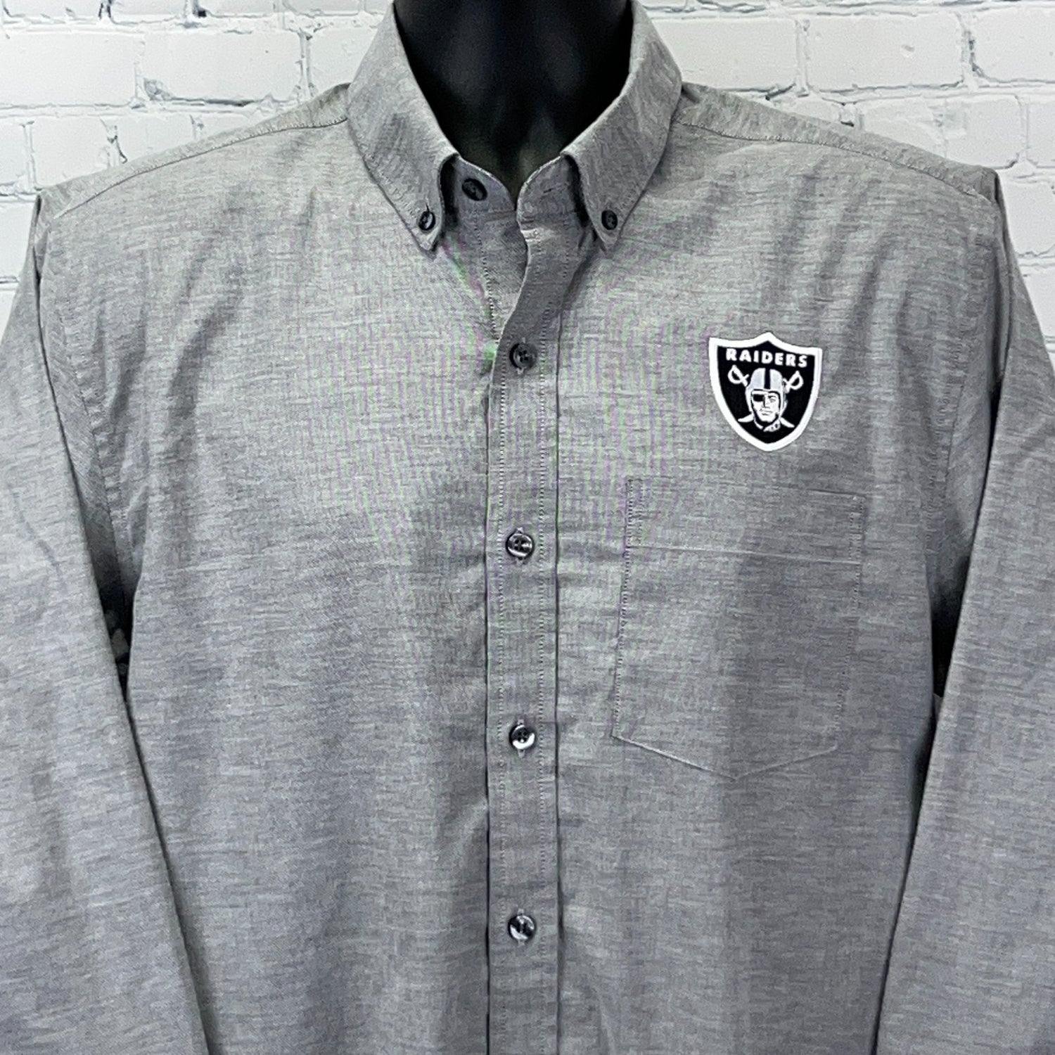 Gray Cutter & Buck button-up shirt featuring Las Vegas Raiders logo on the chest, front view