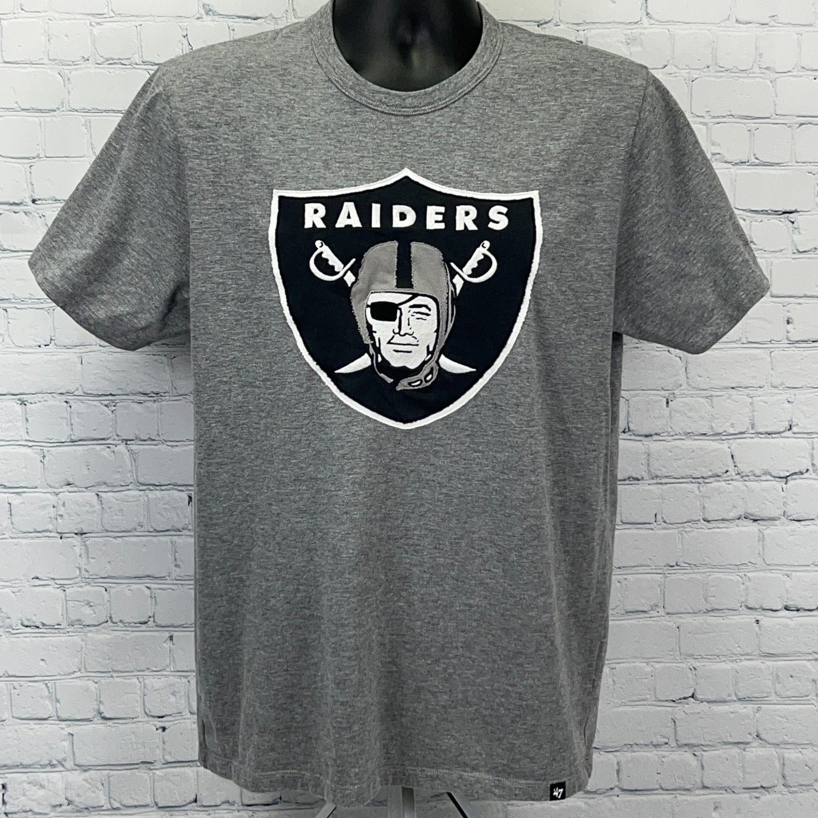 Gray short-sleeve t-shirt featuring the Las Vegas Raiders logo on the front