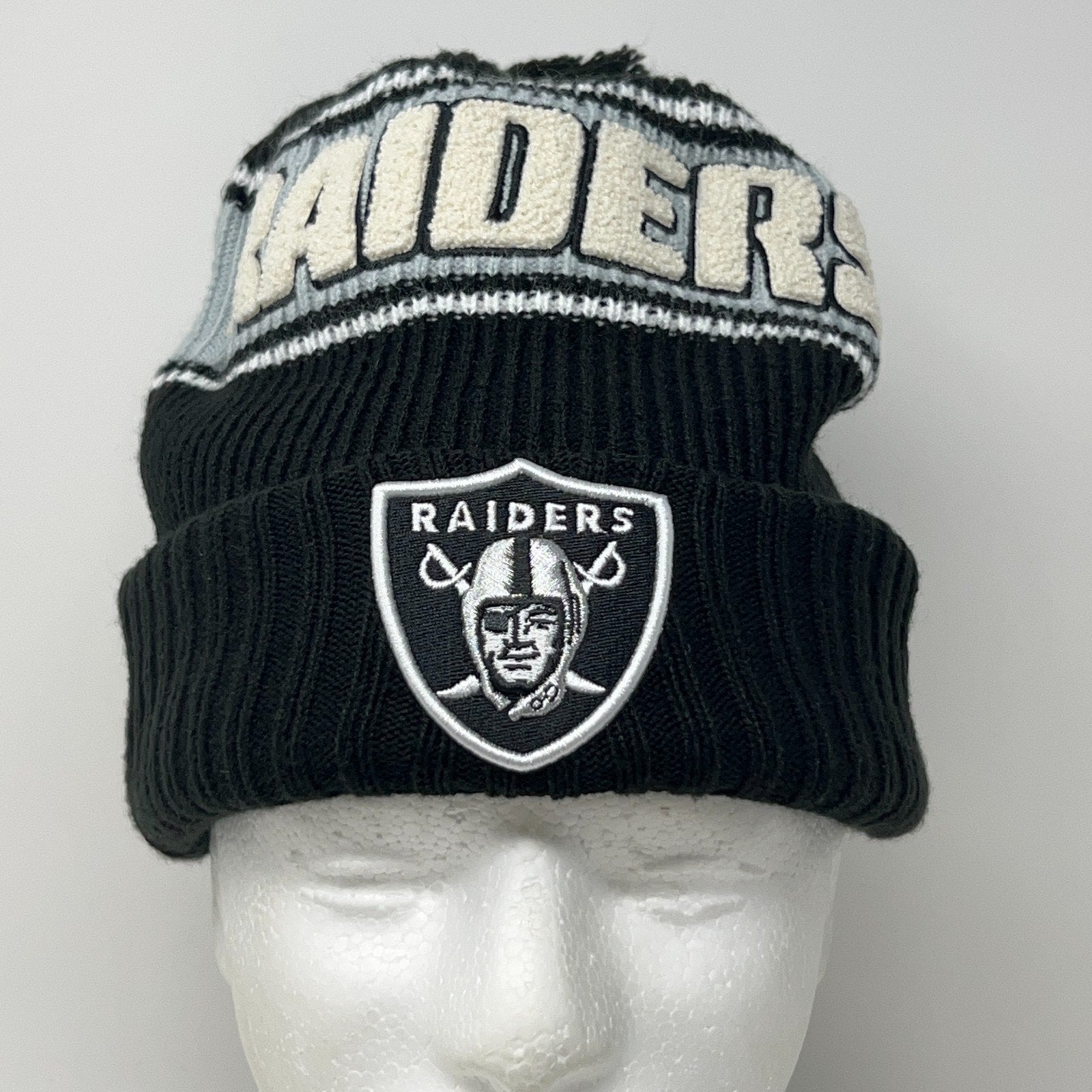 New Era black knit beanie with LAS VEGAS RAIDERS logo and striped design on top