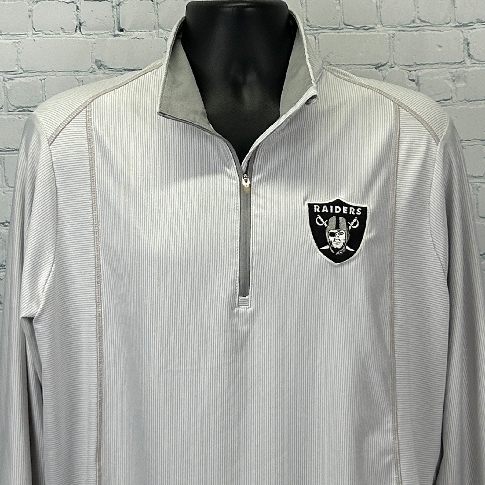 Antigua Las Vegas Raiders Shirt in light gray with quarter zip and team logo on the chest